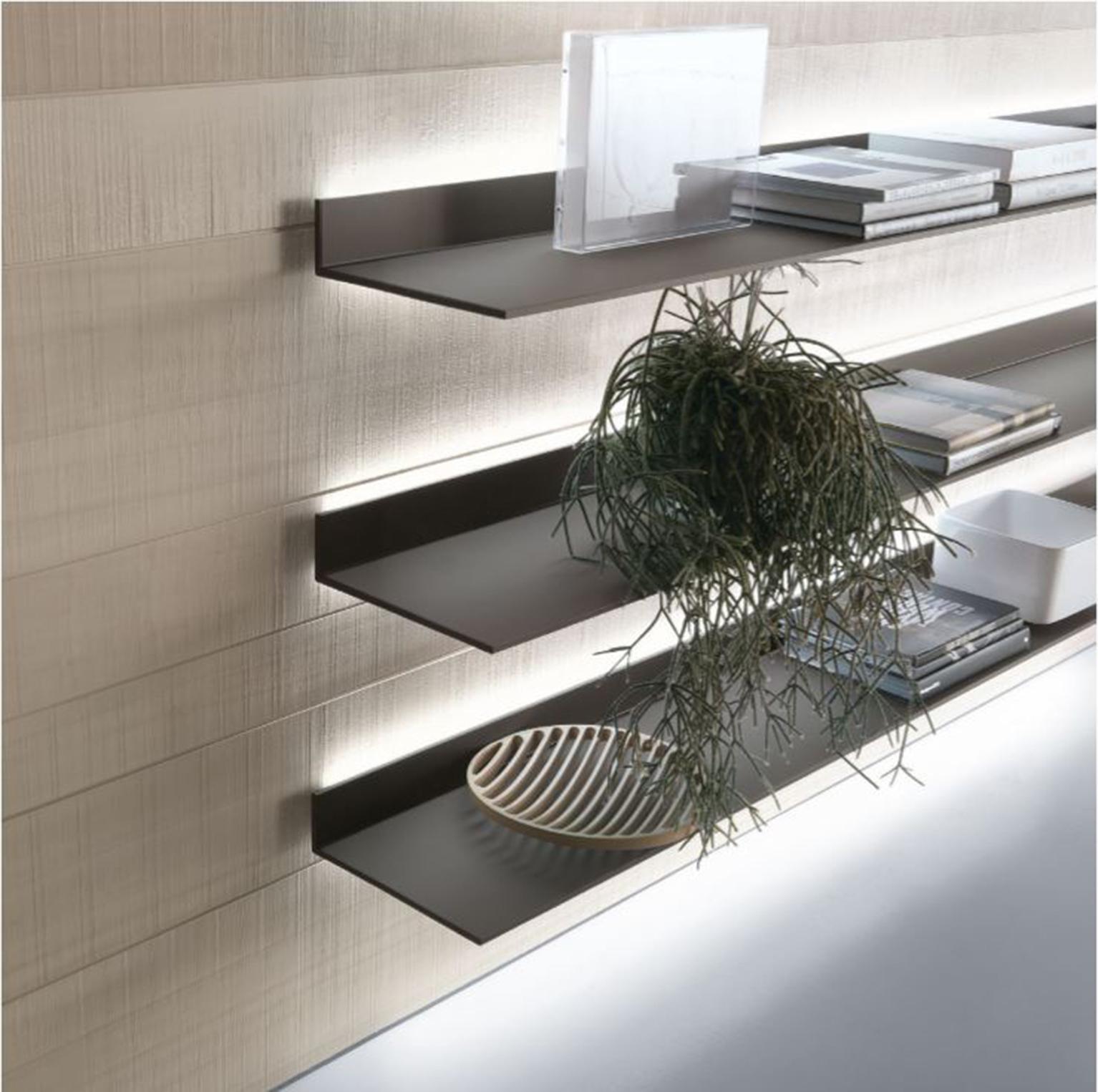The Eos Shelf, designed by Giuseppe Bavuso, is an innovative wall shelving system. With a thickness of only 8 mm, the Eos design combines a lacquered glass top with a lacquered aluminum frame. The wall fixing system ensures installation with no