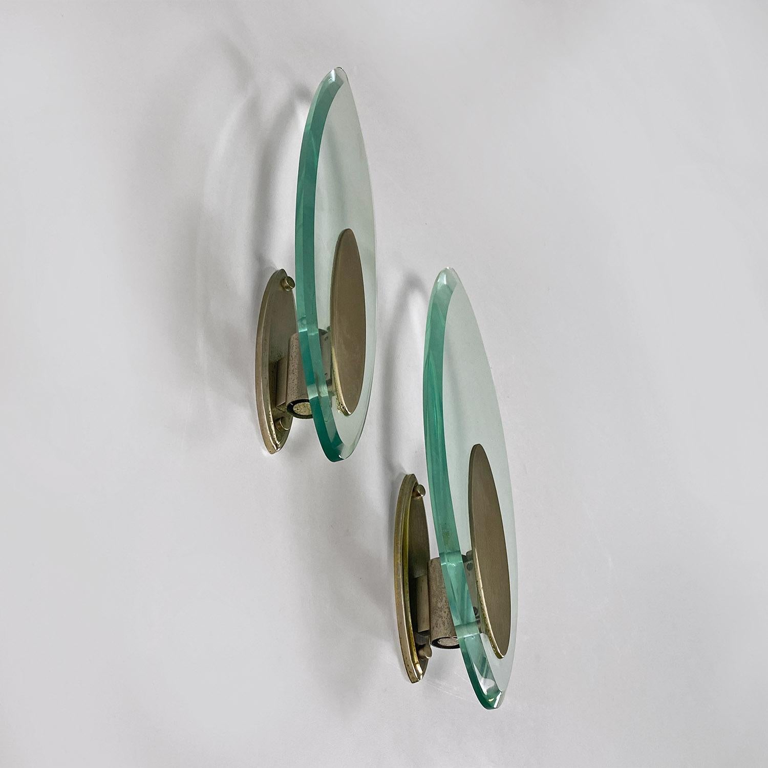 Italian modern glass and brushed steel sconces or wall lamps by Lumi Milano, 1970s.
Pair of glass appliques or wall lamps, with an almost elongated and elongated shape, with a central part in satin steel and a working E 14 socket.
Produced by Lumi
