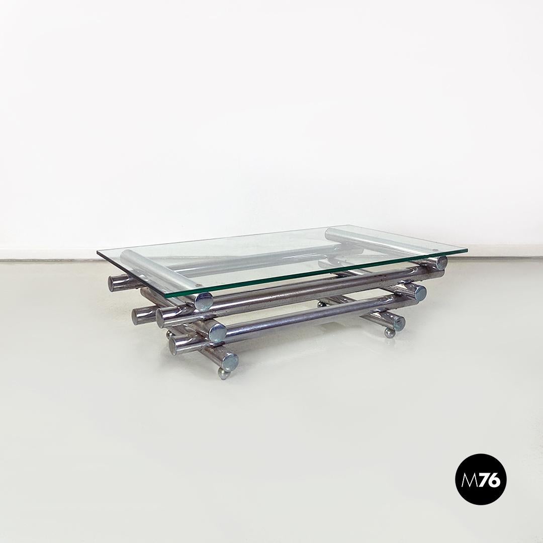 Table basse italienne moderne en verre et acier chromé, années 1970
Table basse rectangulaire avec plateau en verre et base tubulaire multi-niveaux en acier chromé. Pieds sphériques chromés.
1970 environ.
Bon état, avec quelques traces d'oxydation