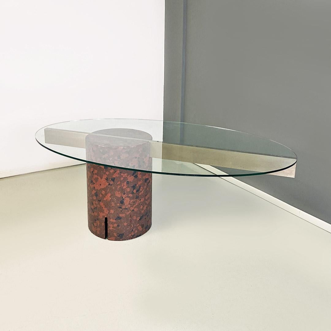 Italian modern glass and camouflage concrete table by Giovanni Offredi for Saporiti Italia, 1980s.
Dining table with elliptical cantilevered glass top and cylindrical concrete support base with camouflage coloring in shades of brick red, brown and