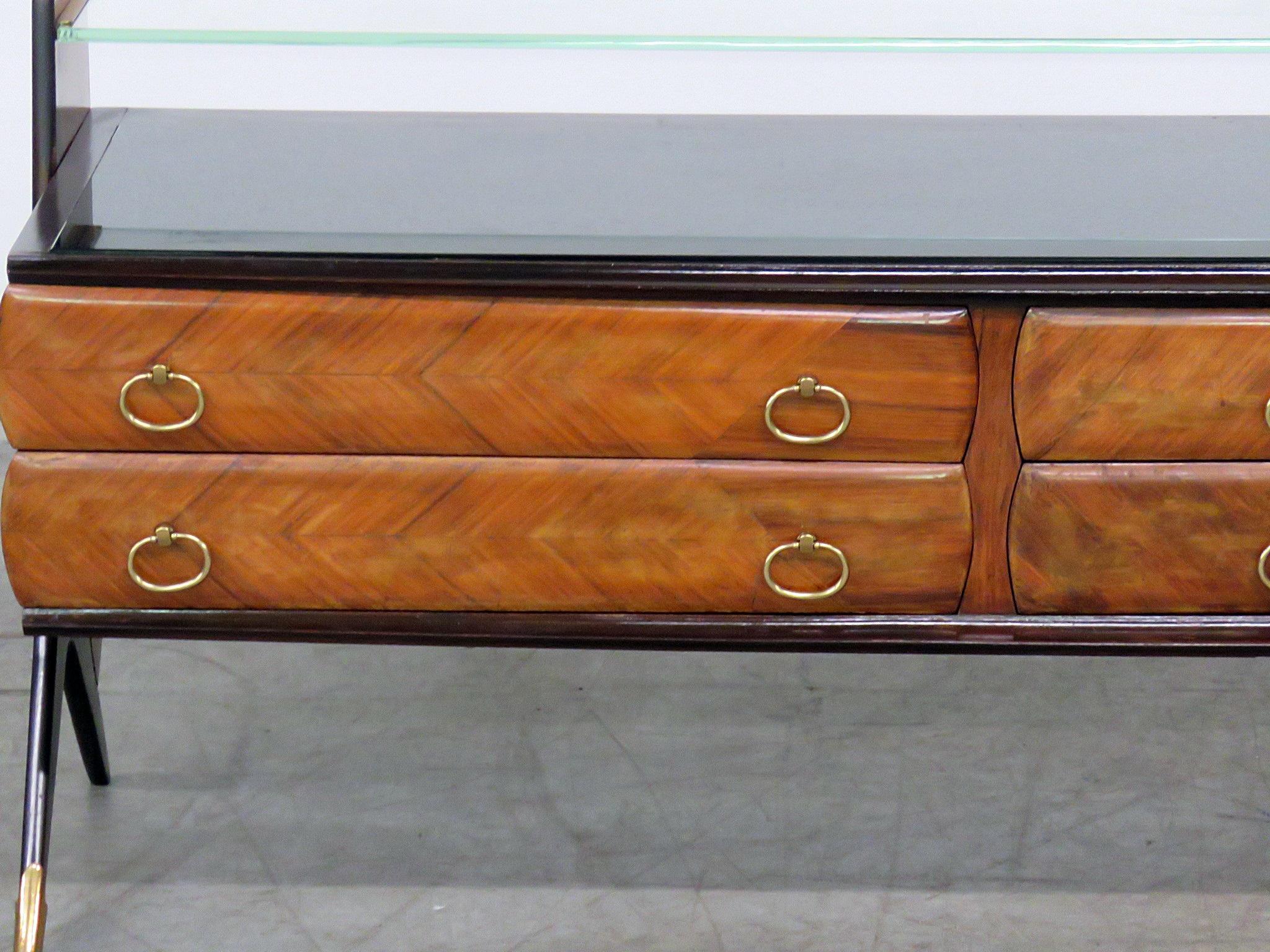 Italian modern glass top credenza with six drawers and brass tips on the front feet.