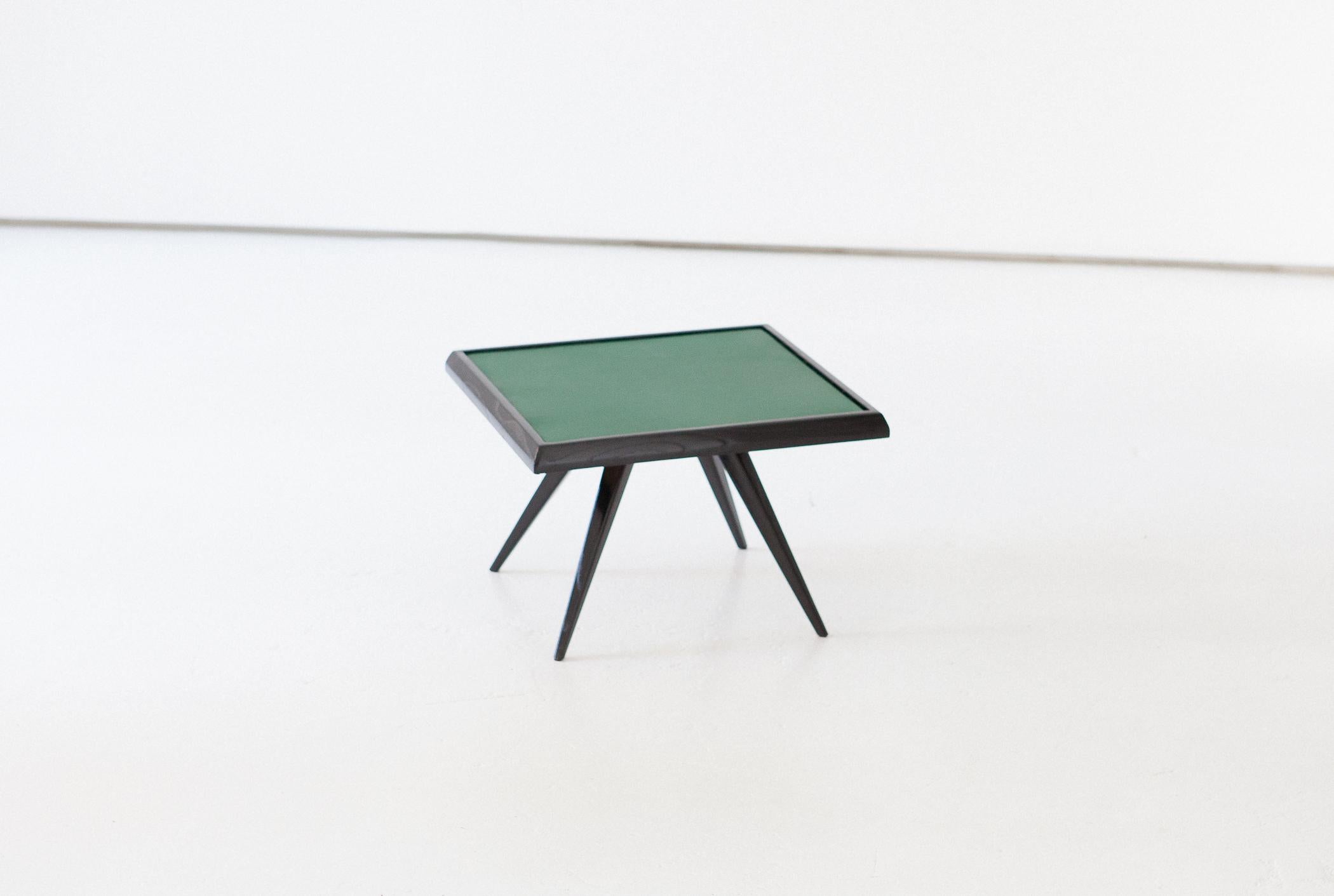 A sculptural and airy low table manufactured in Italy in the 1950s
Solid wood with natural green leather top.
Completely restored, hand polished with natural shellac, aniline black stained.

A Mid-Century Modern style side table.
   