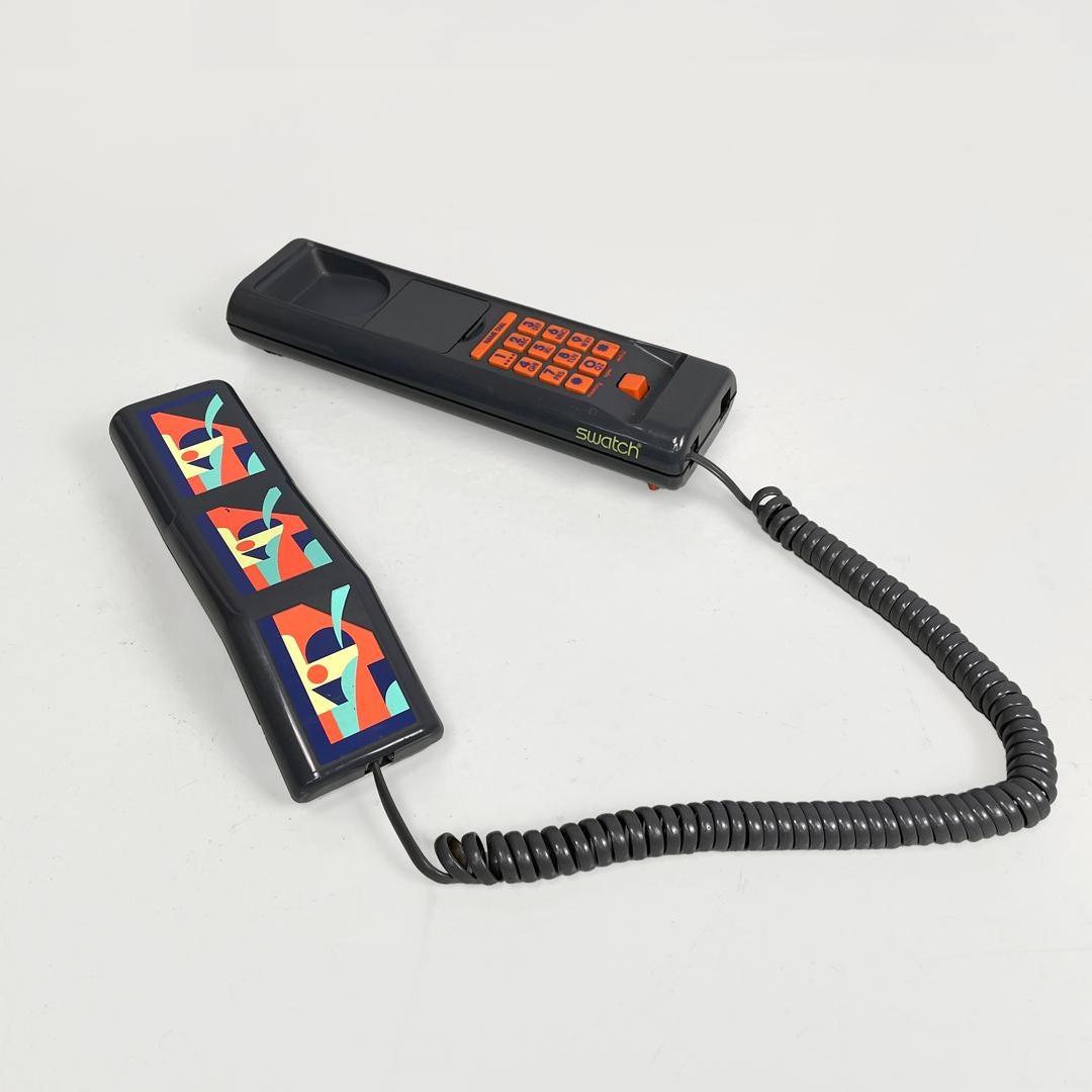 Italian modern grey decorated plastic telephone Twin Phone Deco by Swatch, 1980s
Gray plastic landline telephone. On the handset there are printed geometric decorations, in red, yellow, blue and light blue. The number keys and the side keys are made