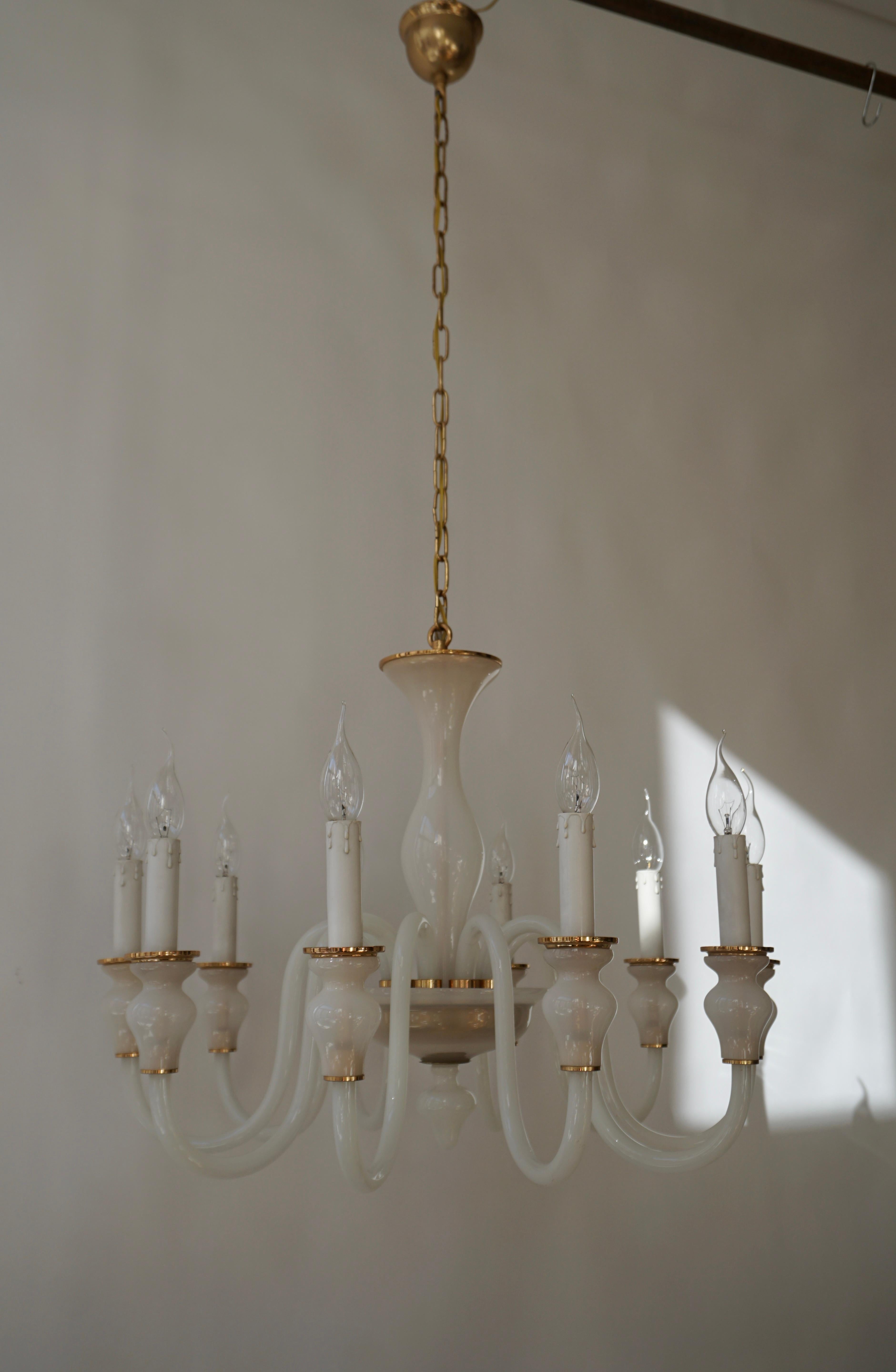 Italian mid-century style hand blown Venetian glass chandelier or pendants in milky white glass, with ten arms, in the modern neoclassical tradition.

The height of the piece without chain is 21.4. With chain it can extend to 49