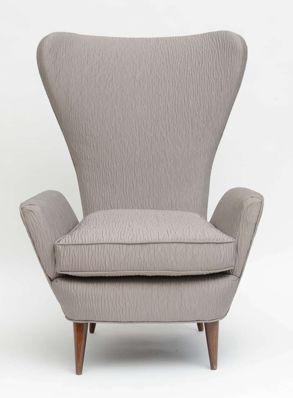 High back armchair of sculptural form with round tapering legs
from the Hotel Presidential, Lake Como, possibly Paolo Buffa.