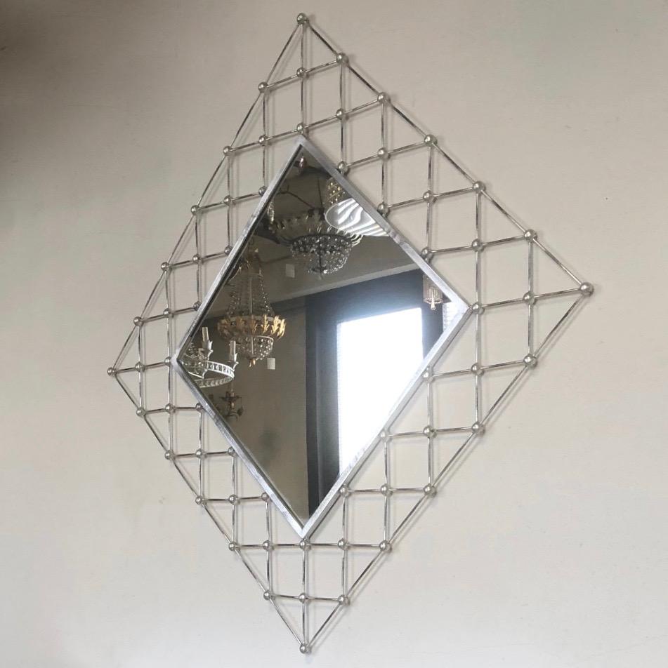 Very stylish contemporary brushed wrought iron lattice mirror, entirely handmade in Italy, the interlaced frame consisting of a well crafted trellis openwork decorated with metal balls at the intersections to enrich the tracery.
Can be accompanied