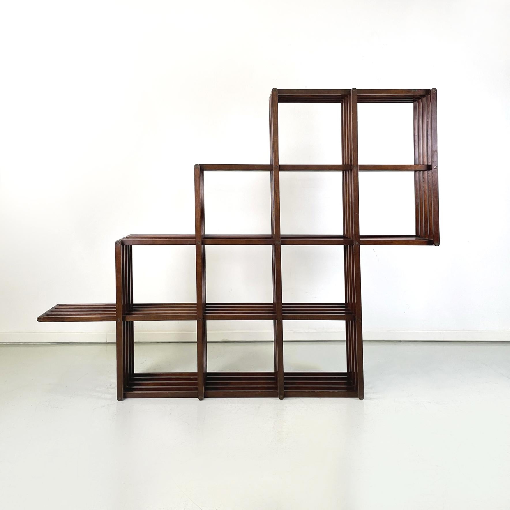 Italian modern Irregular wooden folding floor and wall bookcase by Pool Shop, 1980s
Irregularly shaped  wooden folding bookcase with 11 square compartments and an external shelf. The structure is totally resealable, thanks to the strips that compose