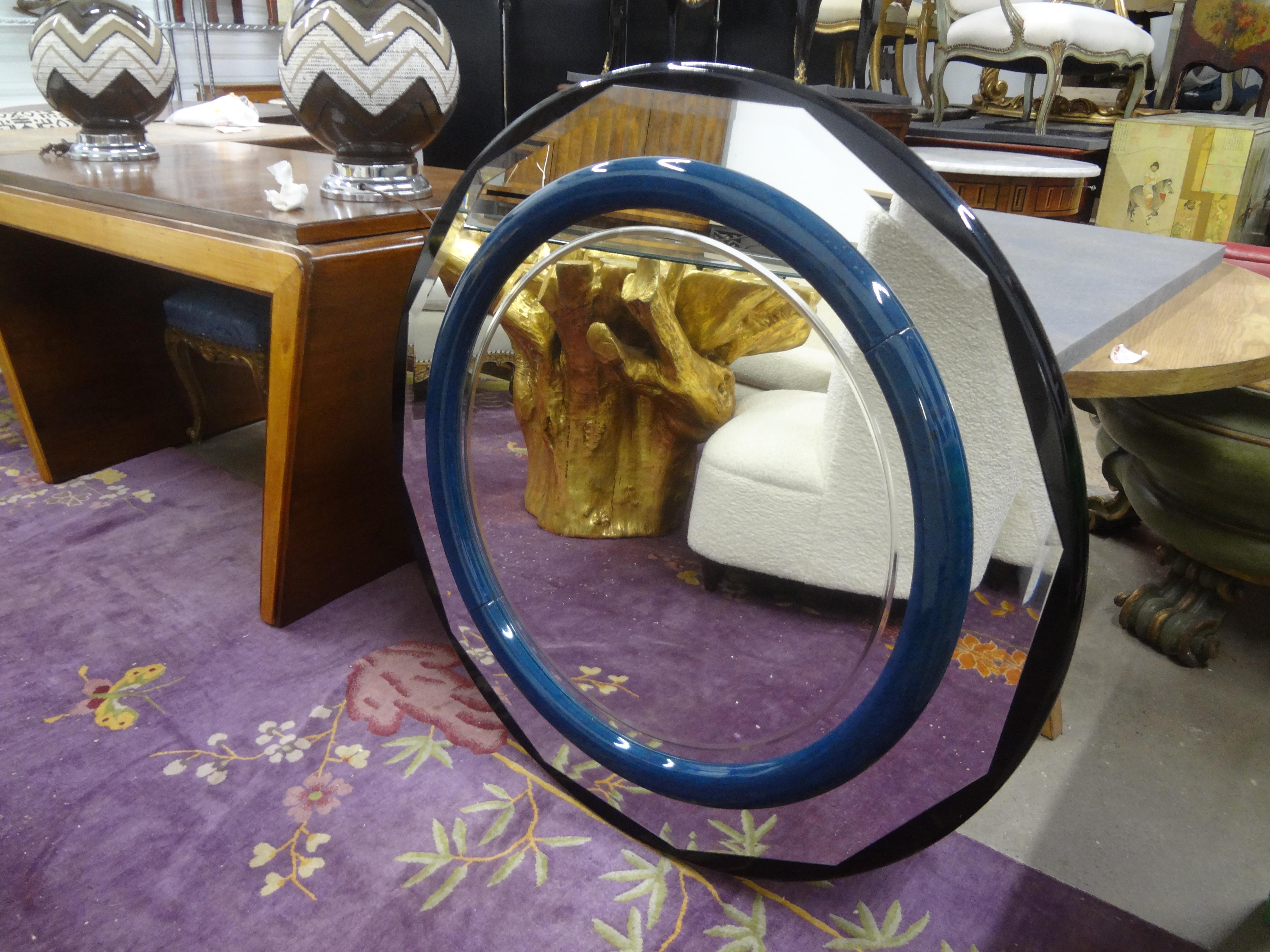 Italian Modern Lacquered Beveled Mirror.
This stunning large round Italian beveled mirror has a perimeter band of black lacquered wood with a blue lacquered central ring. Beautiful beveling on all mirrored parts.
Statement mirror!