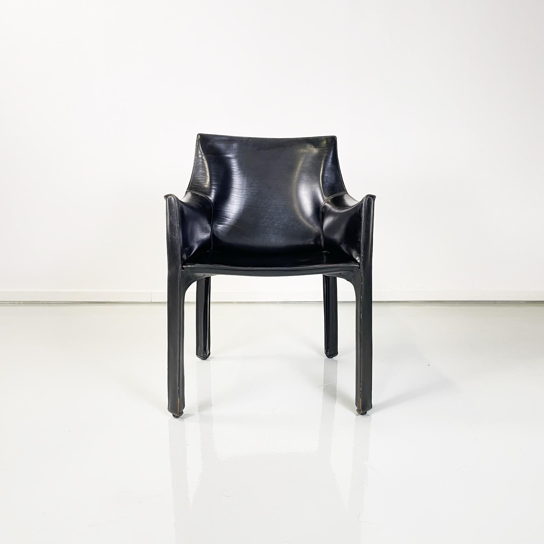 Italian modern Leather armchair mod CAB 414 by Mario Bellini for Cassina, 1980s 
Armchair mod. CAB 414 in black leather. The leather follows the shapes of the seat, back, armrests and square legs. Exposed seams. Under the seat there are hinges that
