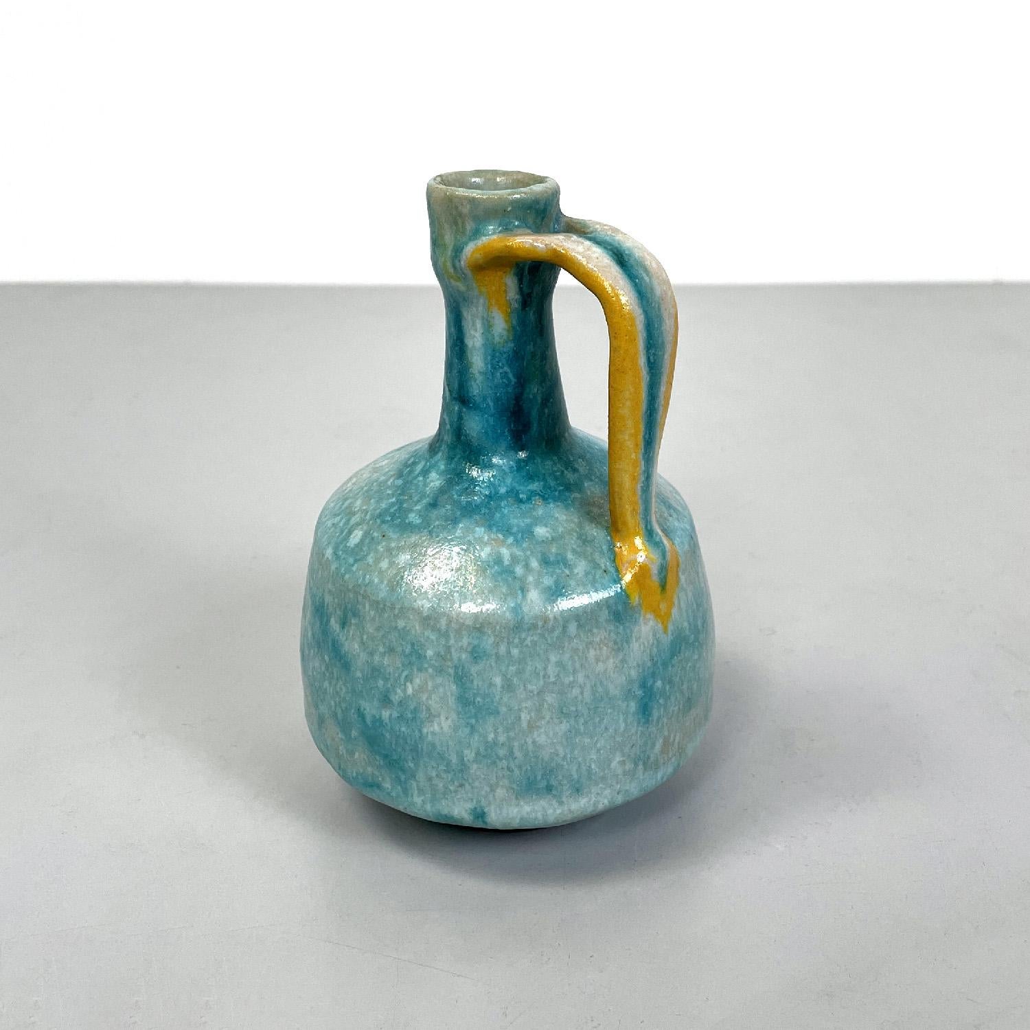 Italian modern light blue and yellow ceramic vase by Bruno Gambone, 1970s
Glazed ceramic vase with round base. The structure has an elongated neck in the upper part, then expands in the lower part, on one side there is a handle that connects the two