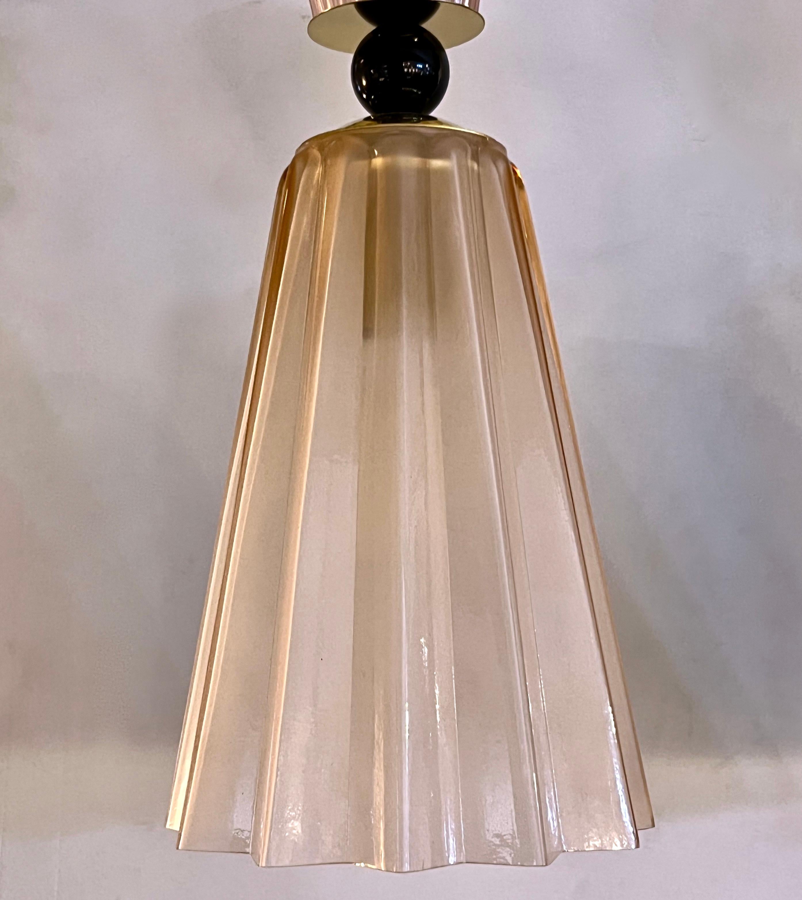 Pendant in opaline blown Murano glass of star shape, in  light pink, also available in smoked gray, and aqua-blue, decorated with a reeded glass cap accompanied with black glass spheres, fitted with a handmade triangular canopy. High quality of