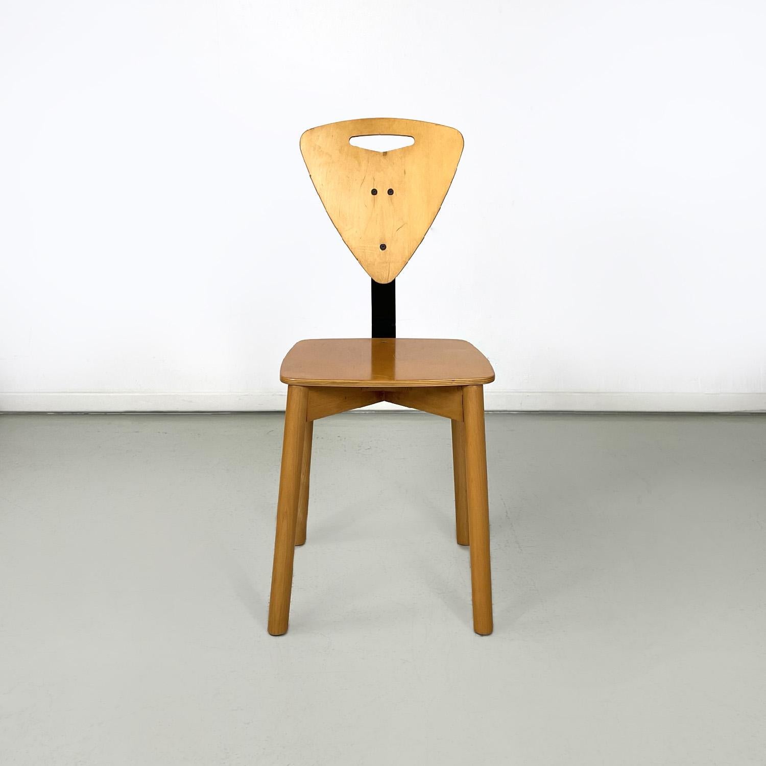 Italian modern light wooden chairs with black metal bars, 1980s
Set of six wooden chairs. The seat is square in shape and has rounded corners; the triangular backrest with an elongated hole is connected to the seat thanks to a black metal band. The