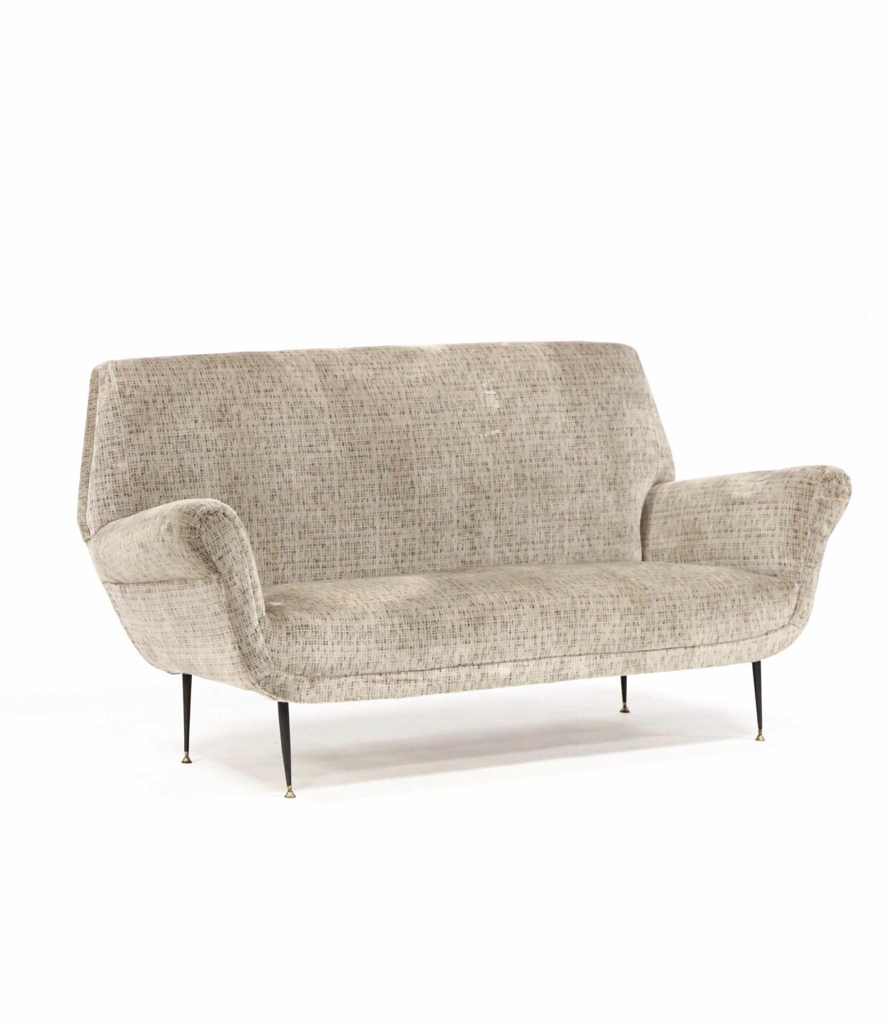 A Classic Italian modern loveseat by Gigi Radice having sexy curves and smartly designed lines. The smaller sofa resides in older clothes that are sturdy and clean yet could use updating depending on your needs. We love this form for mixing all the