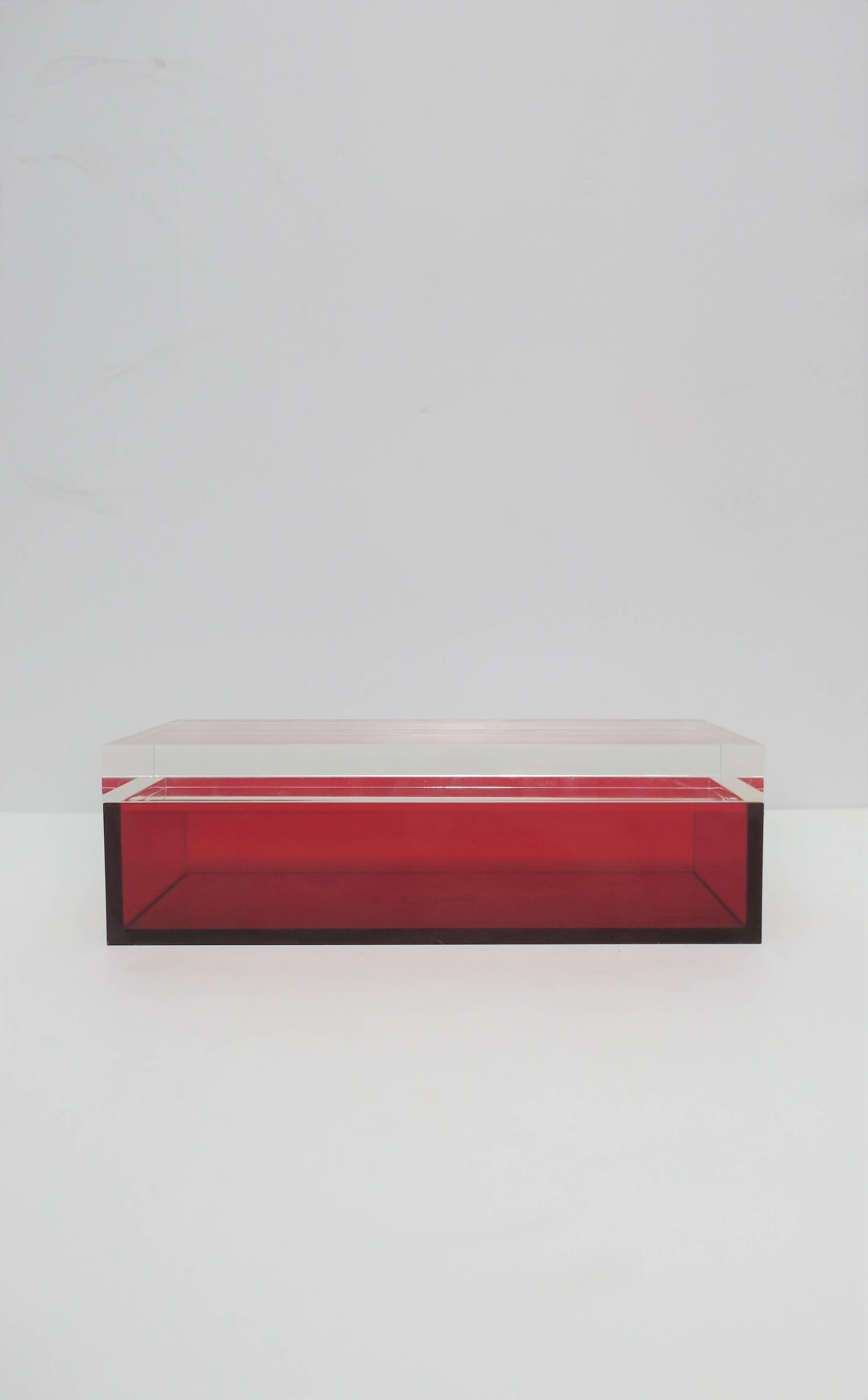 An Italian Postmodern, Modern or Minimalist style, rectangular box by designer Alessandro Albrizzi, Italy, 2005. Box is a translucent red acrylic and a thick clear Lucite top. Designer's mark 
