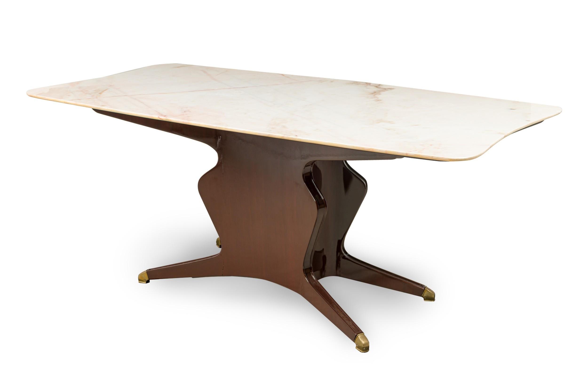 Italian Mid-Century Modern dining / conference table with a shaped rectangular white onyx table top supported by a lacquered mahogany pedestal base with four angled legs ending in brass sabots. (chip to corner of marble top)
 

 Chips in on one