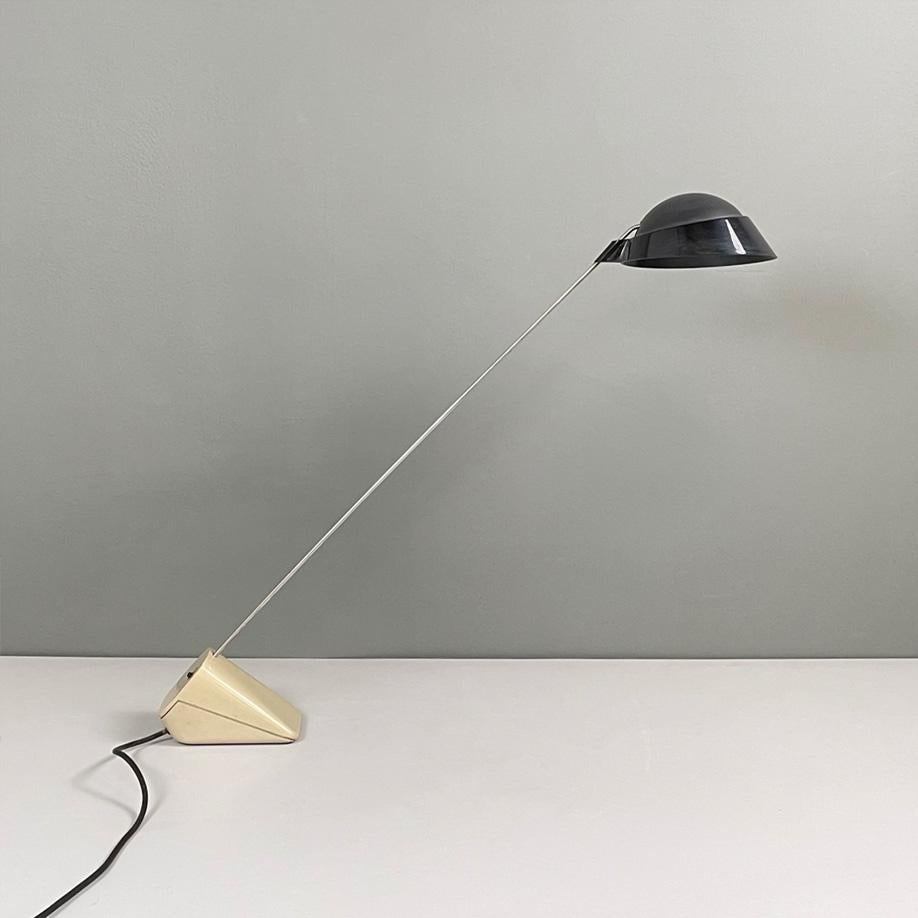 Italian modern metal rod black diffuser and sand plastic base table lamp, 1980s
Table lamp with a rectangular base in plastic and metal. The rounded diffuser is in matte black plastic with glossy profile. The arm is made of silver metal rod and is