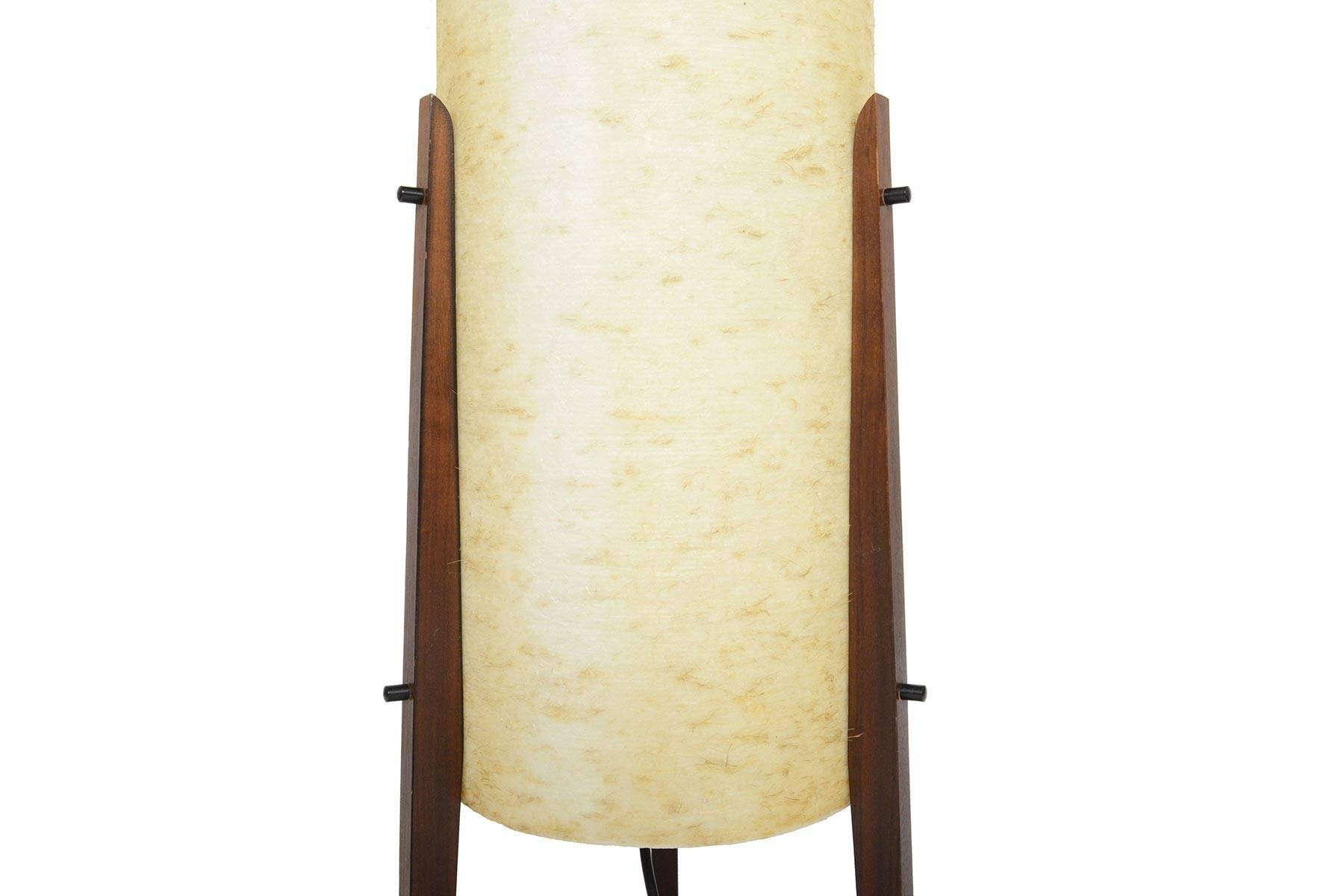 This stunning Italian modern fiberglass tripod floor lamp offers a beautiful warm light in a truly midcentury Silhouette. Three mahogany legs attach to a spun fiberglass shade. In excellent original condition with typical wear for its vintage.

 