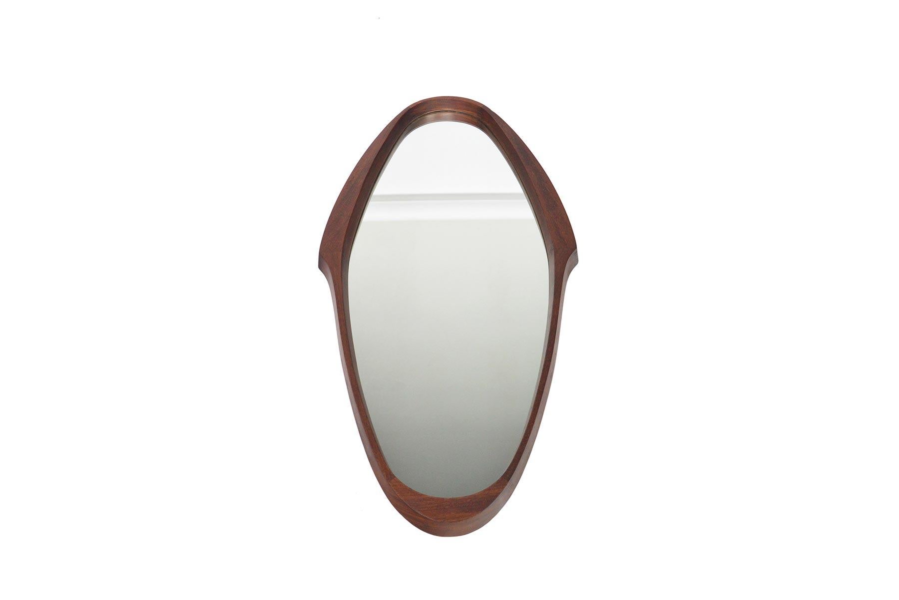 This stunning Italian Mid-Century Modern wall mirror is crafted from solid walnut to create an elegant oval shape. In excellent original condition with typical wear for its vintage.

  