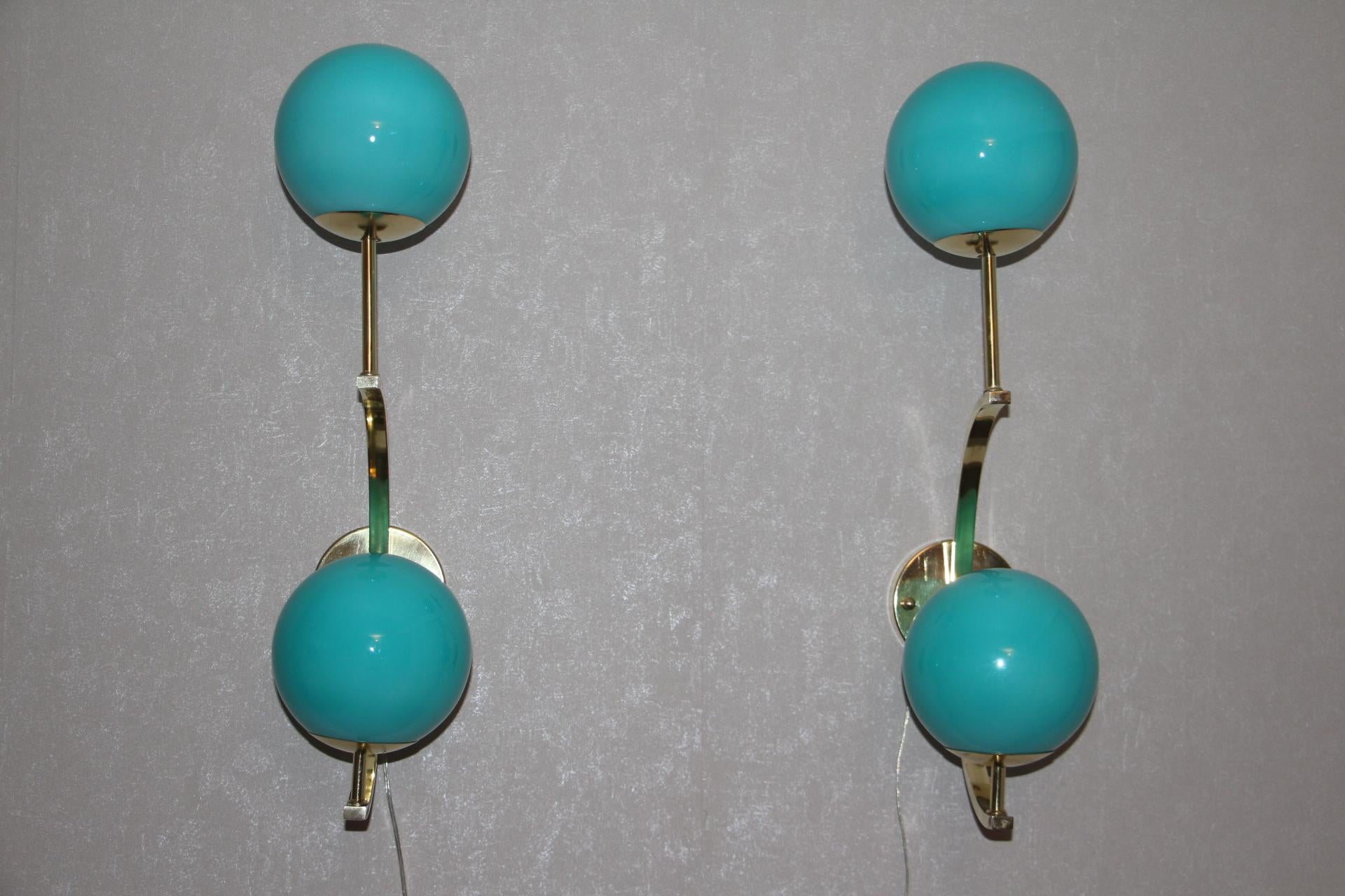 These sconces are very elegant with their brass frame and beautiful turquoise blue Murano glass globes. They have got very unusual geometrical proportions and are very elegant.
Take E14 bulbs. Wired for U.S.
Each sconce is 3 kg.
Globes are