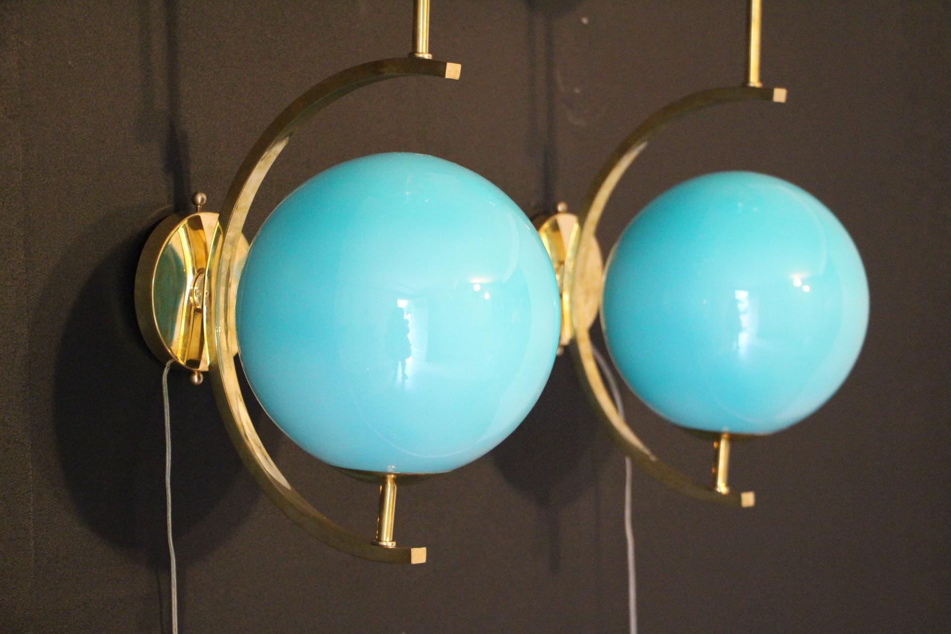 These sconces are very elegant with their brass frame and beautiful turquoise blue Murano glass globes. They have got very unusual geometrical proportions and are very elegant.
Take E14 bulbs. Wired for U.S.
Each sconce is 3 kg.
Globes are