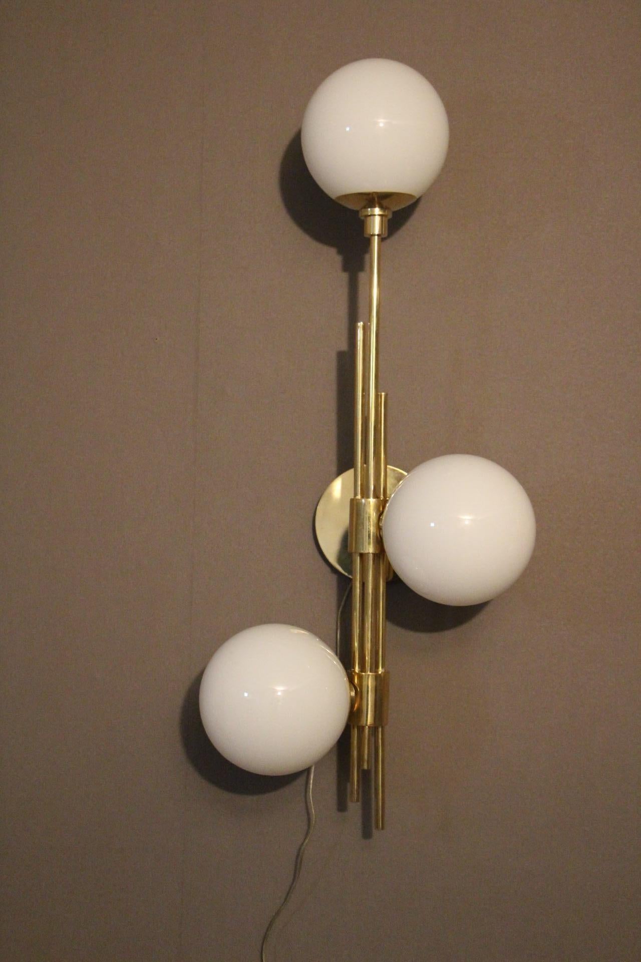 These sconces are very chic with their brass frame and white Murano glass dome. They have got very unusual geometrical proportions and are very elegant.
Takes E14 bulbs. Wired for U.S.
Each sconce weight's is 4 kg.