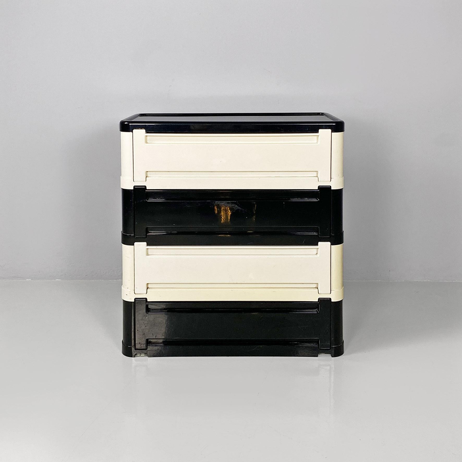 Italian modern modular chest of drawer 4964 by Olaf Von Bohr for Kartell, 1970s.
Modular chest of drawers model 4964 with a rectangular base with rounded corners, with four modules of plastic drawers, with flap, alternating in black and