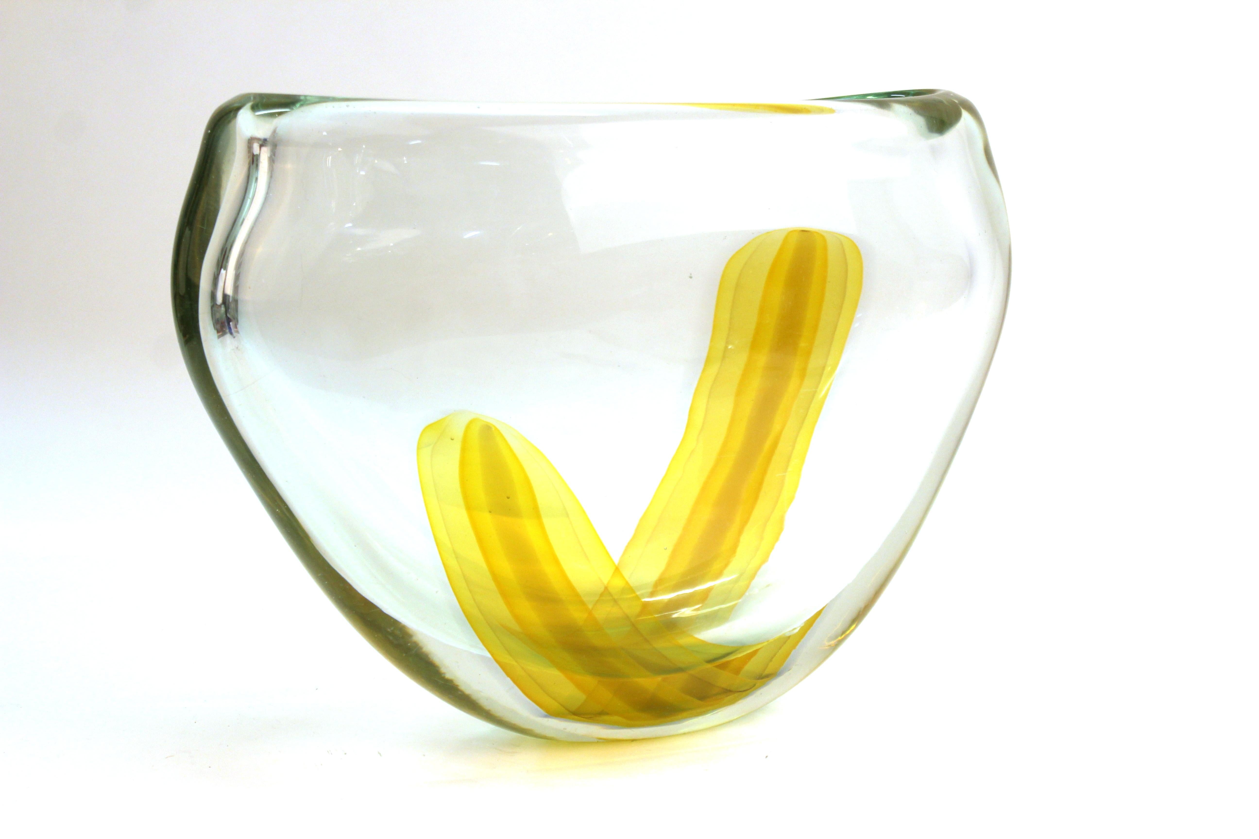 Italian modern art glass vase made in Murano in the late 20th century. The piece has a strip of yellow glass encased in a thick clear glass. In great vintage condition with age-appropriate wear.