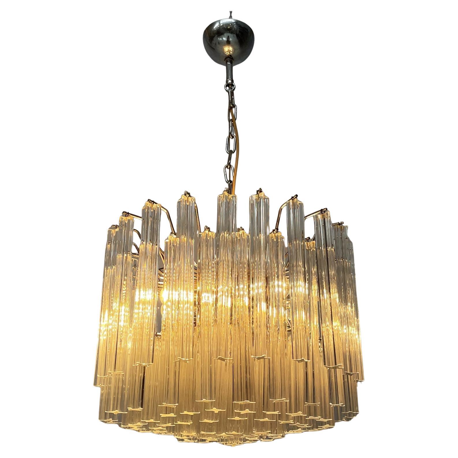 Italian modern Murano glass chandelier by Murano Due, 1970s
Chandelier or ceiling lamp with diffuser composed of numerous shaped glass strips, which are hung from the central round structure thanks to metal rods. The lamp has eight light bulbs.