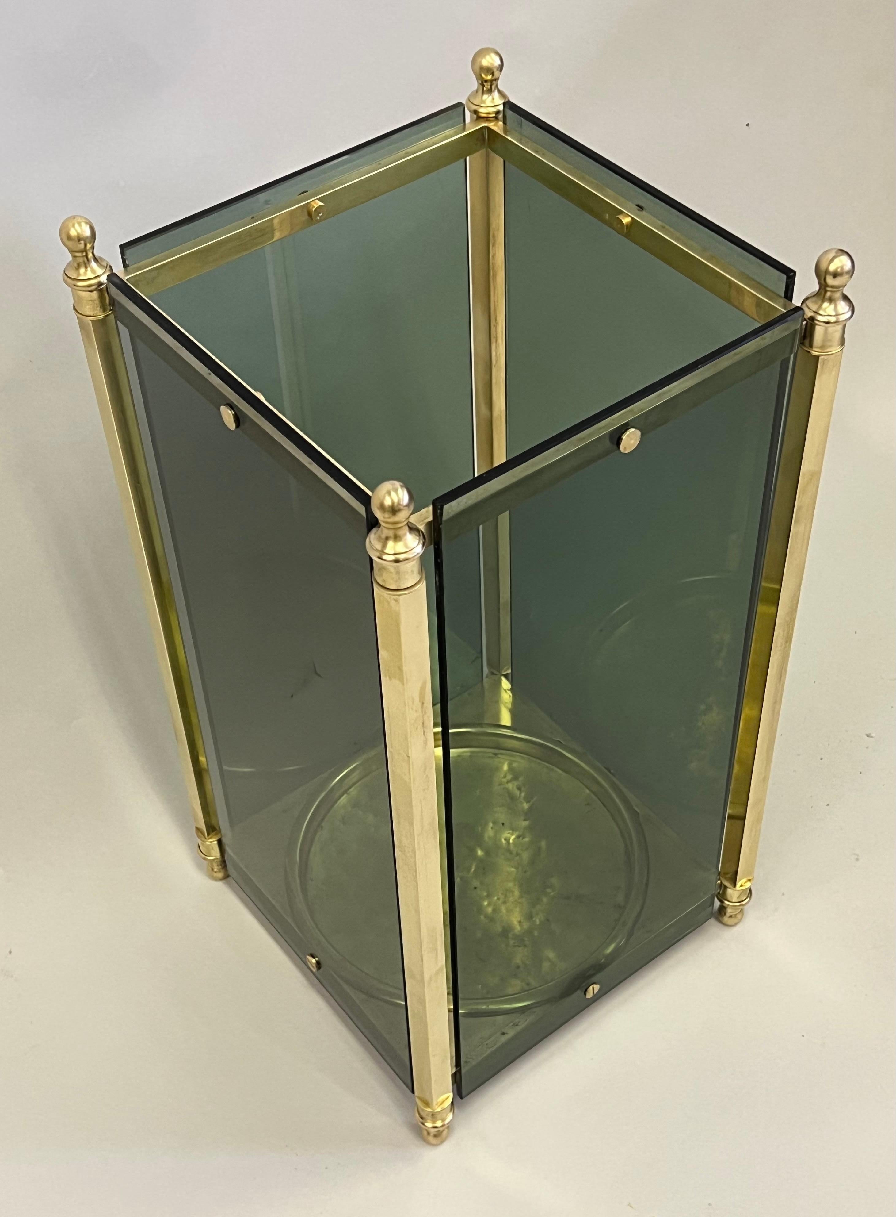 A rare, elegant Italian Mid-Century Modern neoclassical umbrella stand by Fontana Arte. The piece is composed of a solid brass frame with a brass center plate and finished with brass finials, brass rivets and exquisite finishing throughout; the