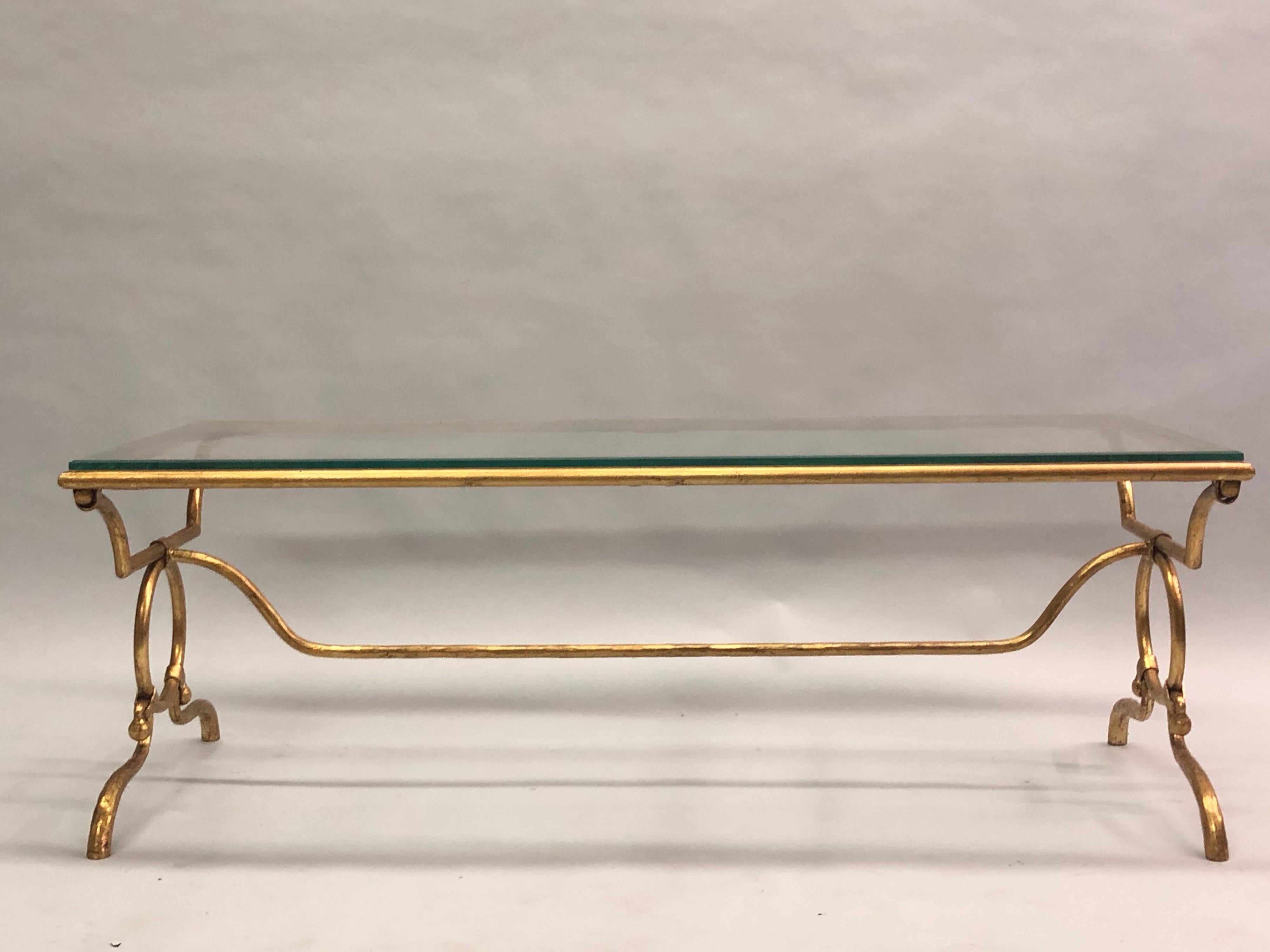 Italian Mid-Century Modern neoclassical gilt iron cocktail table by Giovanni Banci for Hermès with a pair of Hermès Classic horse bit symbols forming the base. 

The piece is shown without a stone top but a choice of stone tops are available at