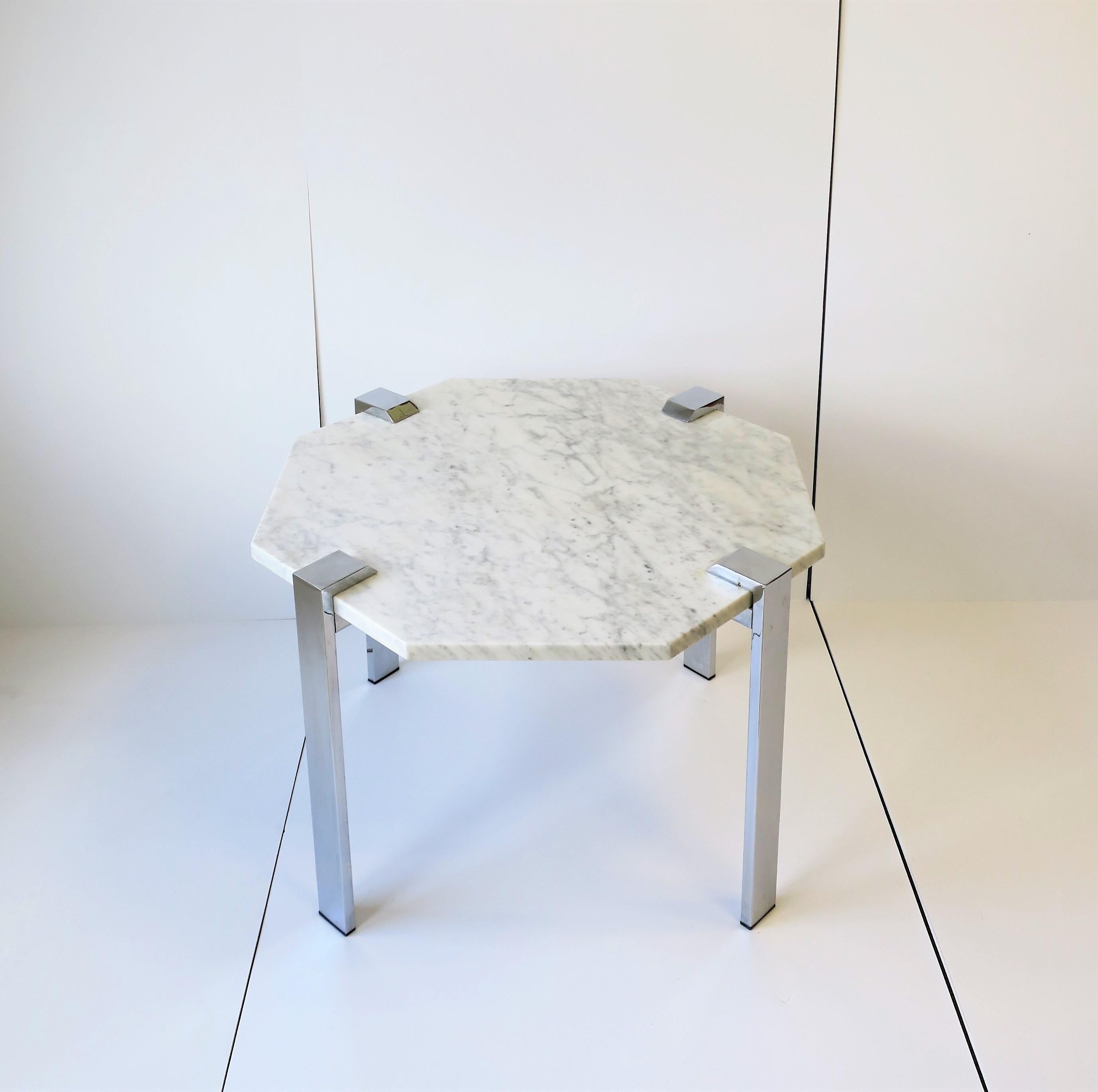 A substantial Italian '70s modern or postmodern [Post-Modern] chrome and Carrara white marble side, end or coffee/cocktail table from Italy, circa 1970s. Carrara marble octagonal top is white with shades of grey/dark grey veining, measuring 3/4