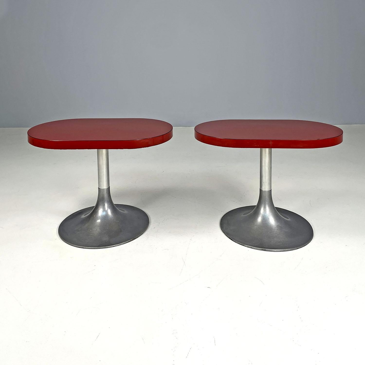 Italian modern oval coffee tables with red laminate tops, 1980s 
Pair of coffee tables with oval top. The wooden top is covered in red laminate, as is its thickness. They feature a central metal stem and Tulip style base.
1980s.
Vintage condition,
