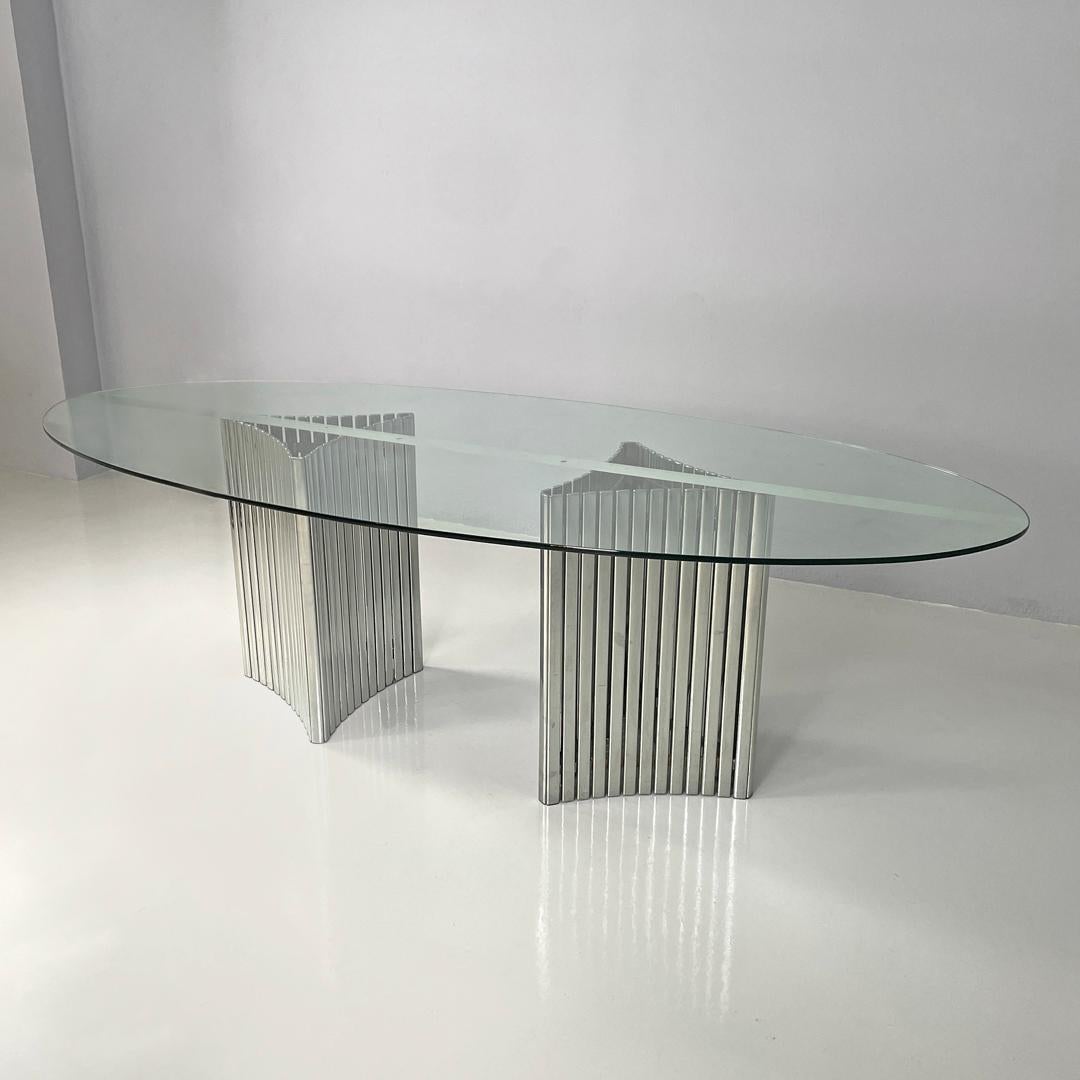 Italian modern oval glass top dining table with chromed metal columns, 1970s In Good Condition In MIlano, IT