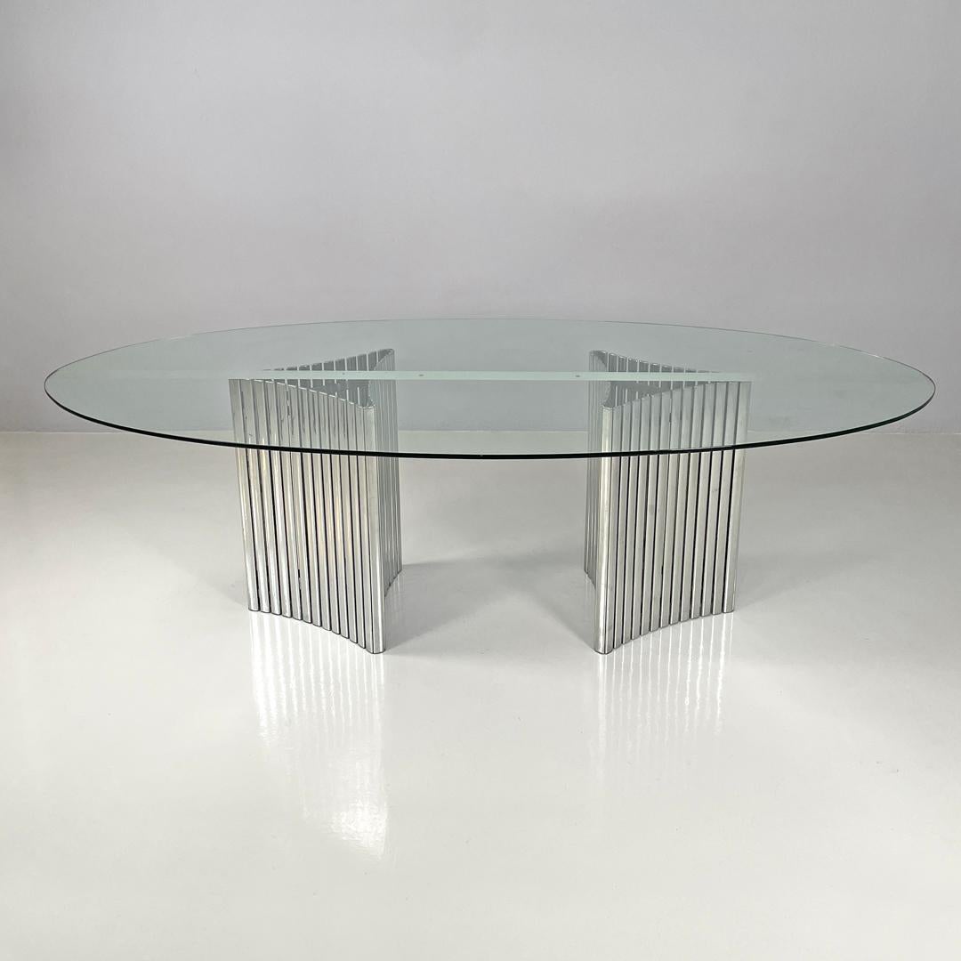 Metal Italian modern oval glass top dining table with chromed metal columns, 1970s