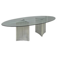 Italian modern oval glass top dining table with chromed metal columns, 1970s