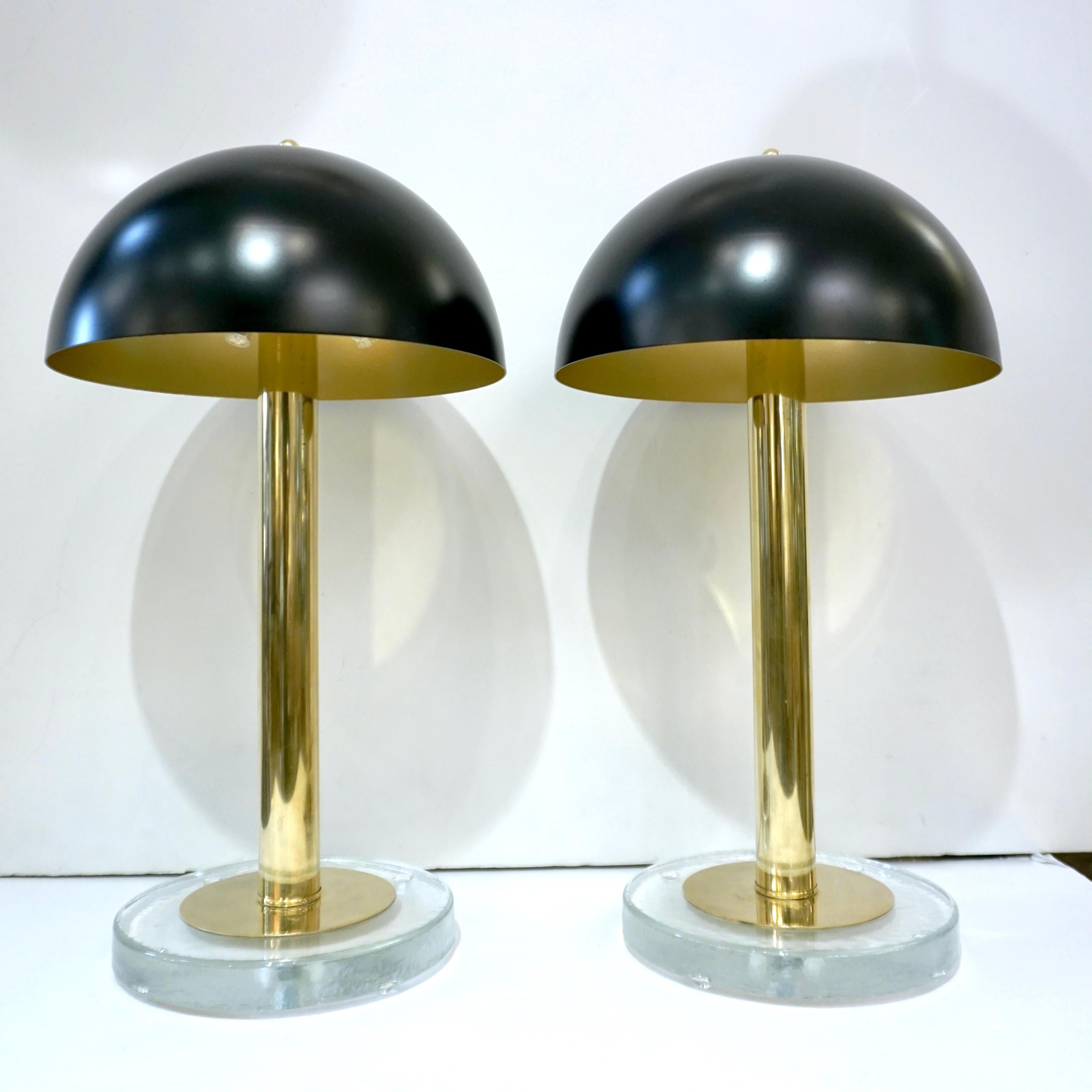 Minimalist elegant design! for this pair of lamps, entirely handcrafted in Italy, with hovering brass dome top shades, high quality of craftsmanship, and attention to detail: the outside of the cupola is lacquered in black and the inside is gold for