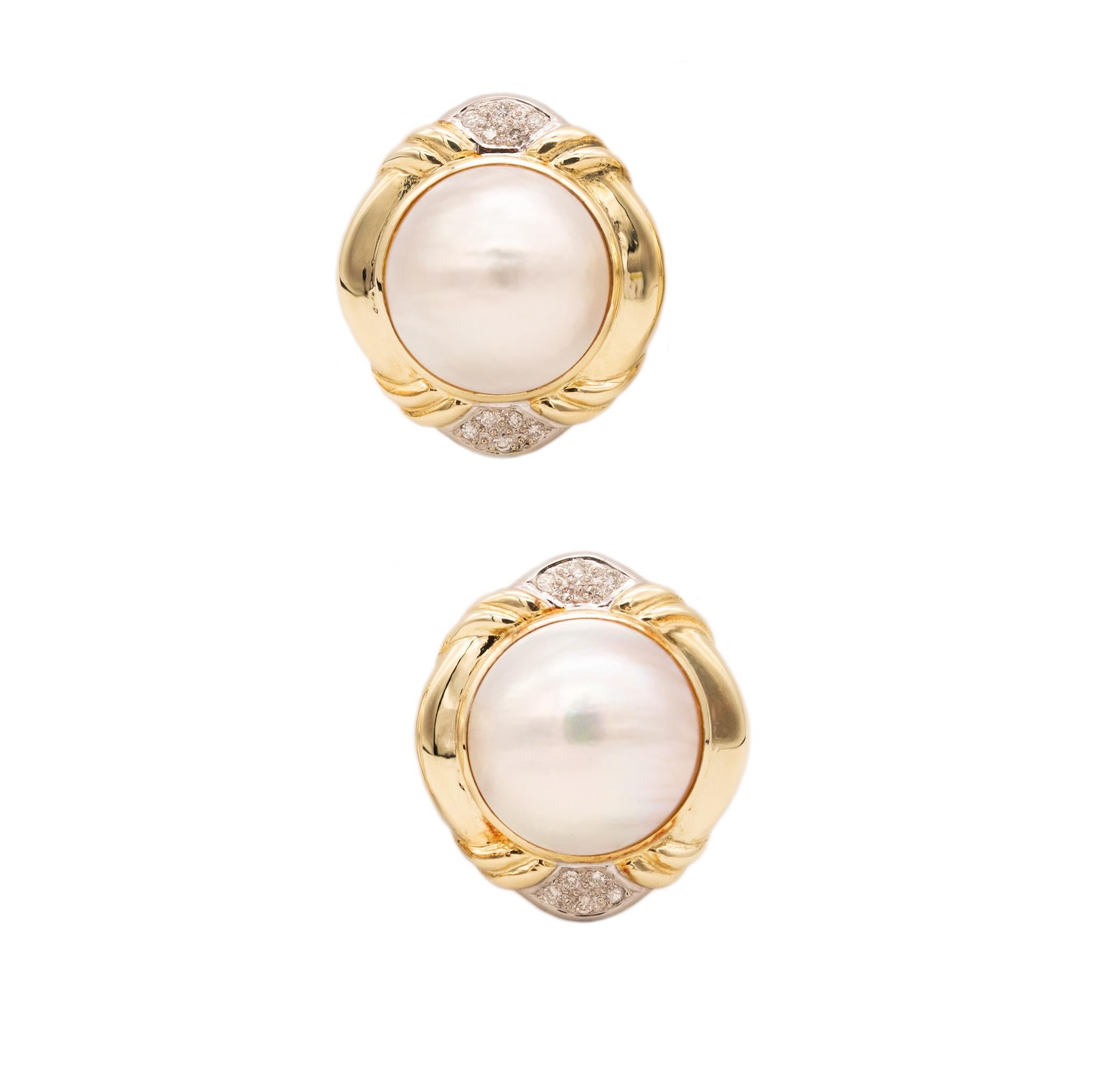 A pair of earrings with Mabe Pearls and diamonds.

Modern over-sized pieces crafted in Italy in solid 14 karats yellow gold and suited with posts (Removable) for pierced ears and French omega backs for fastening clips.

They are bezel set, with a