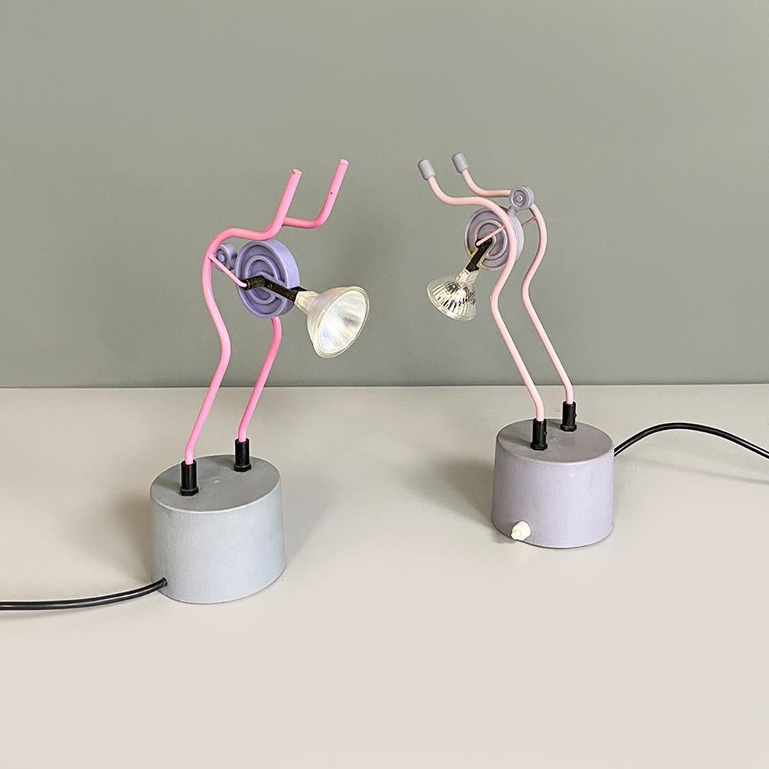 Italian modern pair of pink metal table lamp sculpture, 1980s
Pair of lamps with gray cylindrical base, where the switch is located, with halogen bulb and double inclined metal stem, colored pink for one and lilac for the other.
1980s
In good
