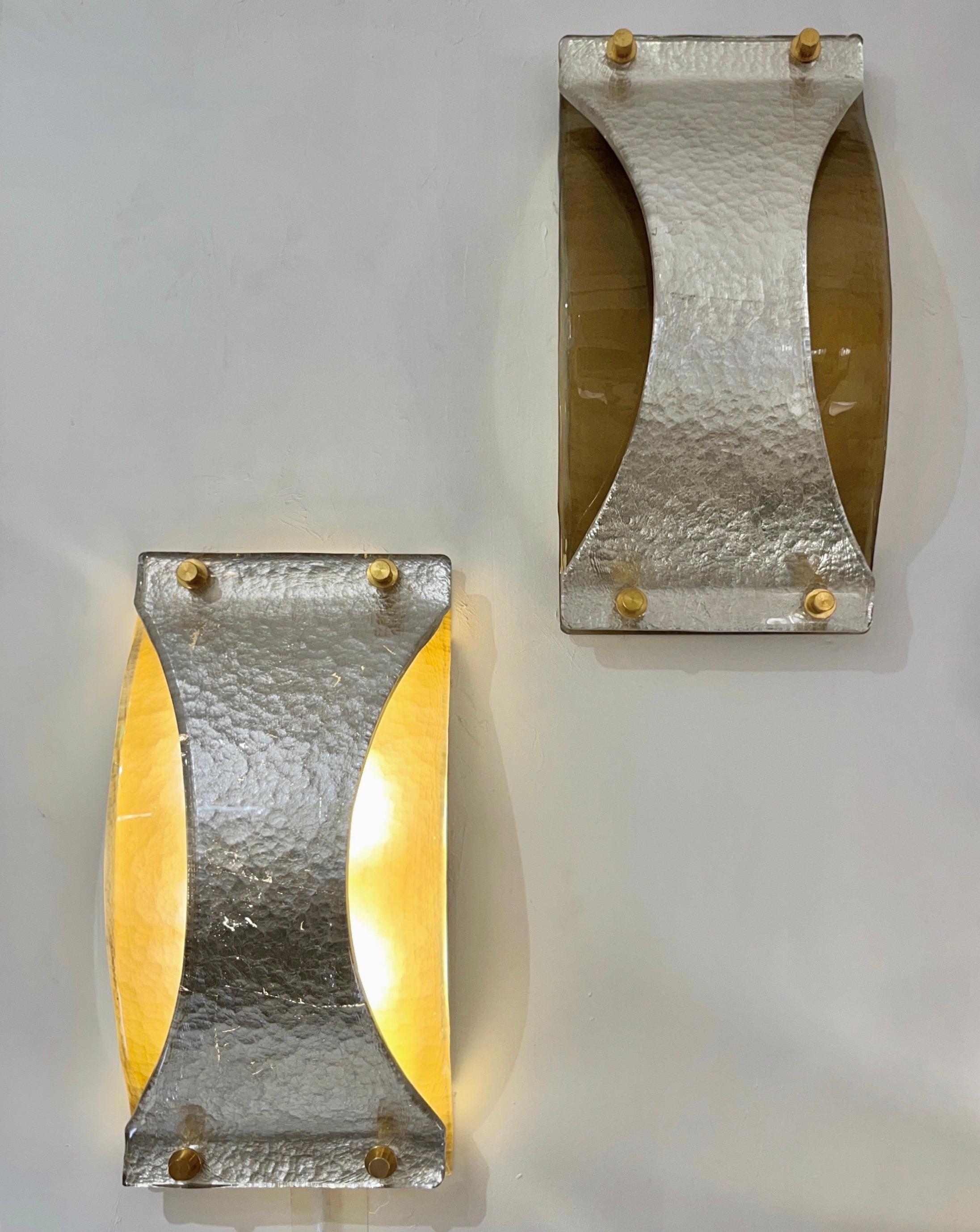 Bespoke Italian Pair of Double Layered Murano Glass Curved Brass Sconces or flushmounts , an aerodynamic design with minimalist rectangular shape, enhanced by brass sides supporting a smoked Murano glass curved cover, with a hammered texture,
