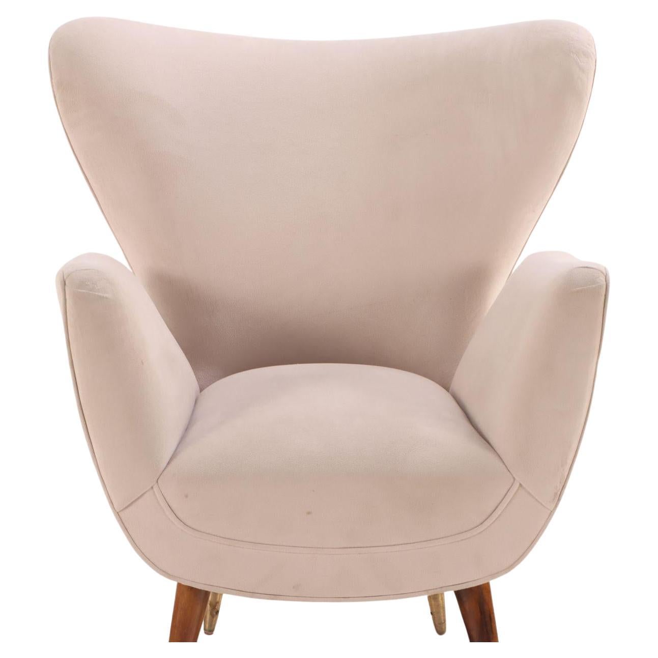 Pair of Paolo Buffa Italian lounge chairs, c. 1950s. Sleek and stylish, these chairs feature a classic cream color on sturdy wooden legs. 

A pair of 1950s Italian lounge chairs would be a striking addition to any mid-century modern collection.
