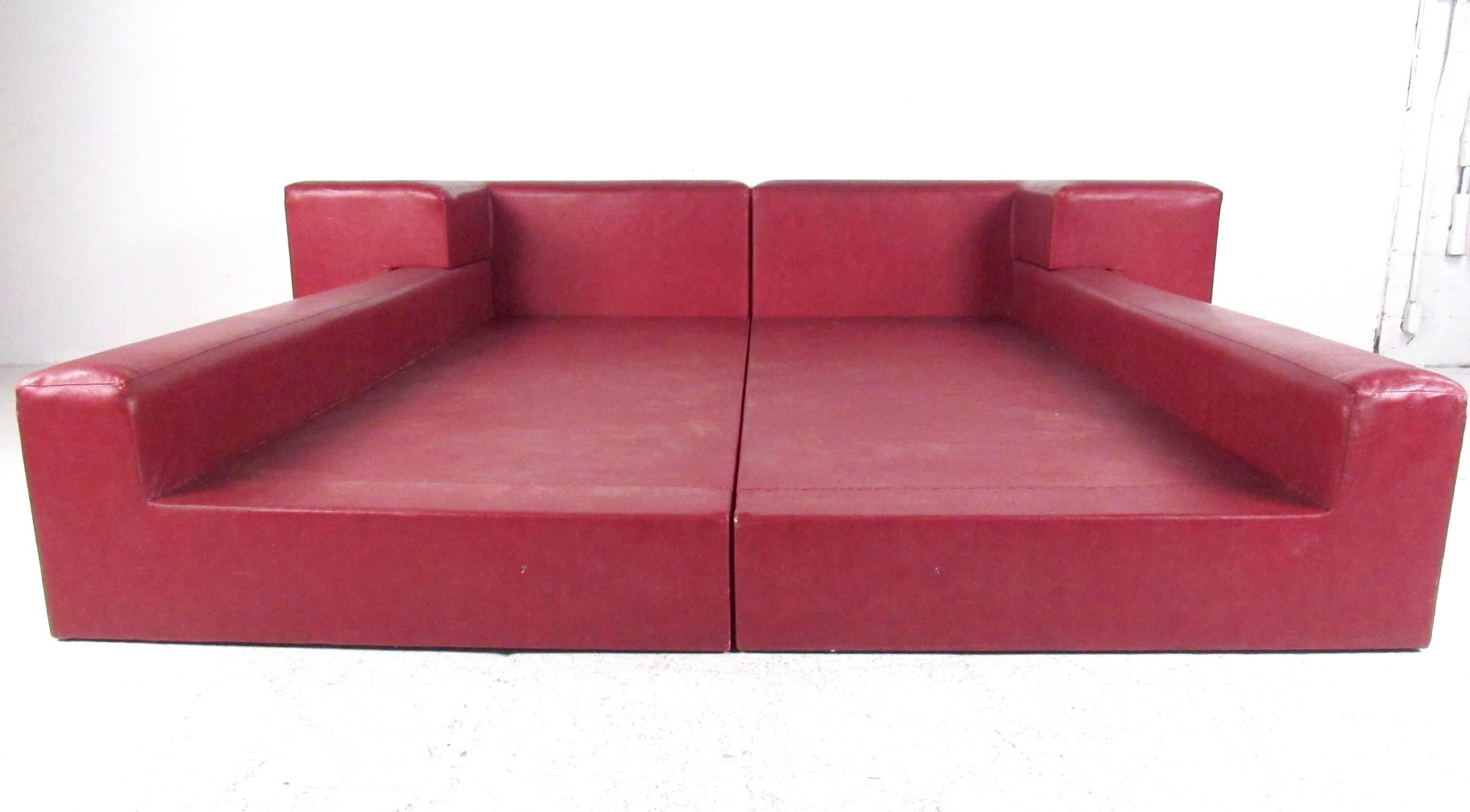 This stylish Italian Modern platform bed with headboard features vibrant red naugahyde upholstery and makes a unique impression in any interior. This padded bed frame provides striking midcentury style for any bedroom setting Please confirm item