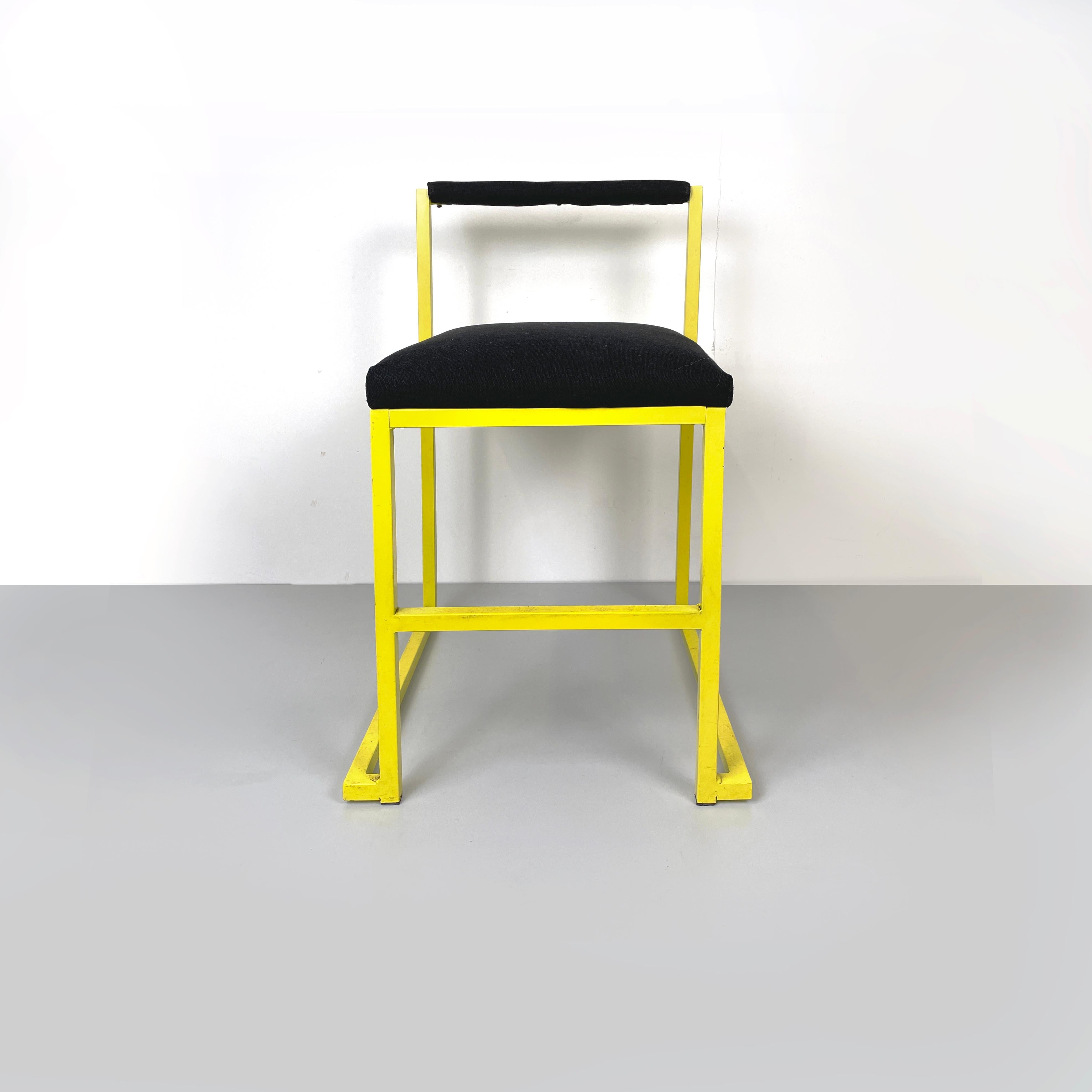 Italian modern Rectangular chair with black fabric and yellow metal, 1980s
Chair with rectangular seat and backrest, padded and covered in black fabric. The square section structure is in yellow painted metal. On the front there is a footrest.
1980