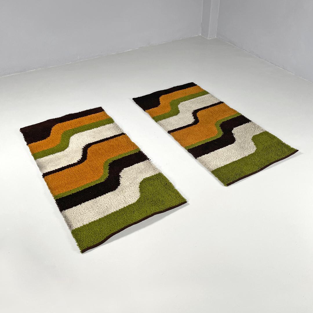 Italian modern rectangular rugs with wavy decorations in green and orange, 1970s
Rectangular elongated rugs, decorated with wavy bands in brown, orange, beige and green.
Produced in 1970s. With label on the back 