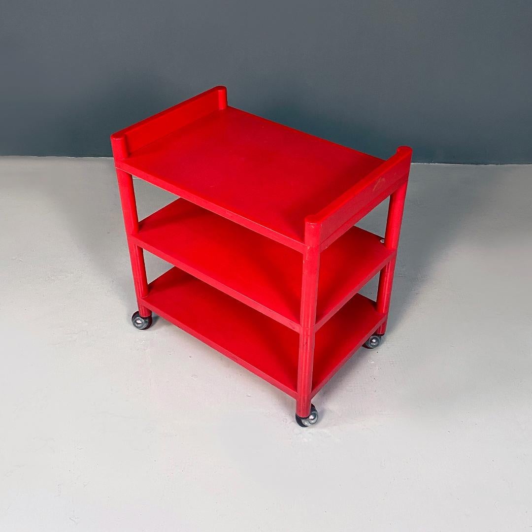 Modern Italian modern red plastic trolley with three shelves and wheels, 1980s