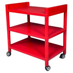 Italian modern red plastic trolley with three shelves and wheels, 1980s