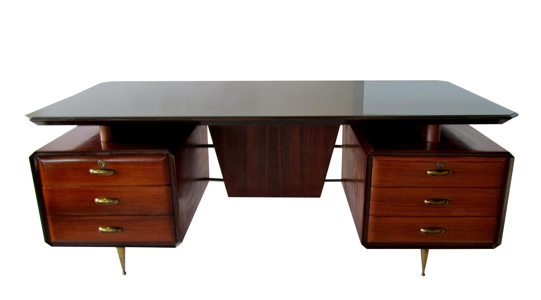 An exceptional desk attributed to Melchiorre Bega (1898-1976), circa 1955, Italian architect and designer, from a long line of cabinet makers. You can tell he paid attention by the details in this piece. Constructed of rosewood, mahogany, glass and