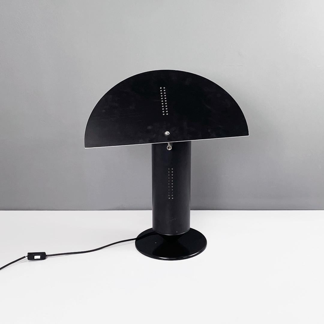 Italian modern round base matte black and glossy white metal table lamp, 1980s
Table lamp with round base in matte black metal. The cylindrical structure is in black metal with small holes that allow the light to come out. Semicircle metal lampshade