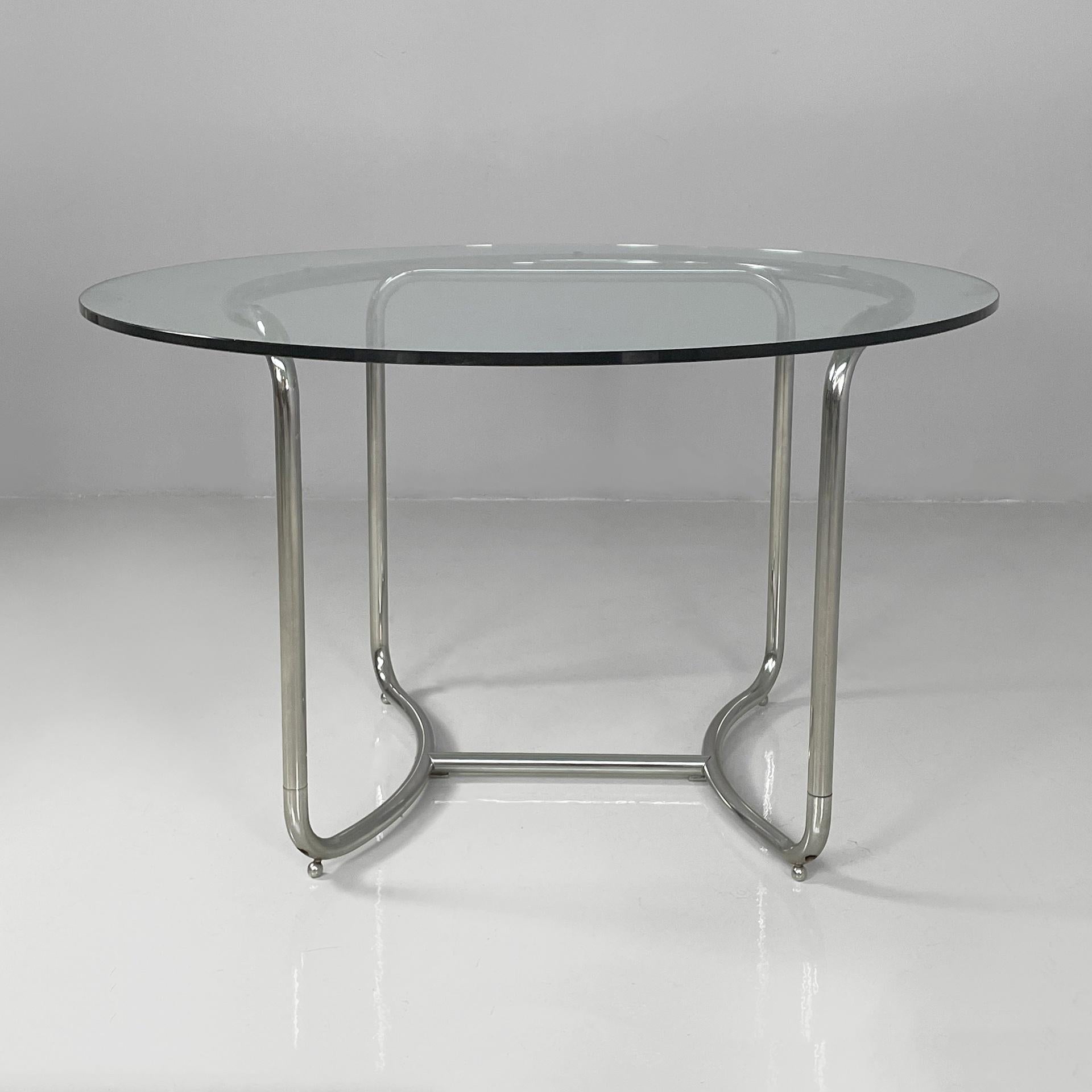 Italian modern round glass and steel dining table by Vittorio Introini, 1970s
Dining table with a round top in thick glass. The strucutre and legs are made of curved chromed steel tubing. Chromed steel spherical feet.
Produced and designed by