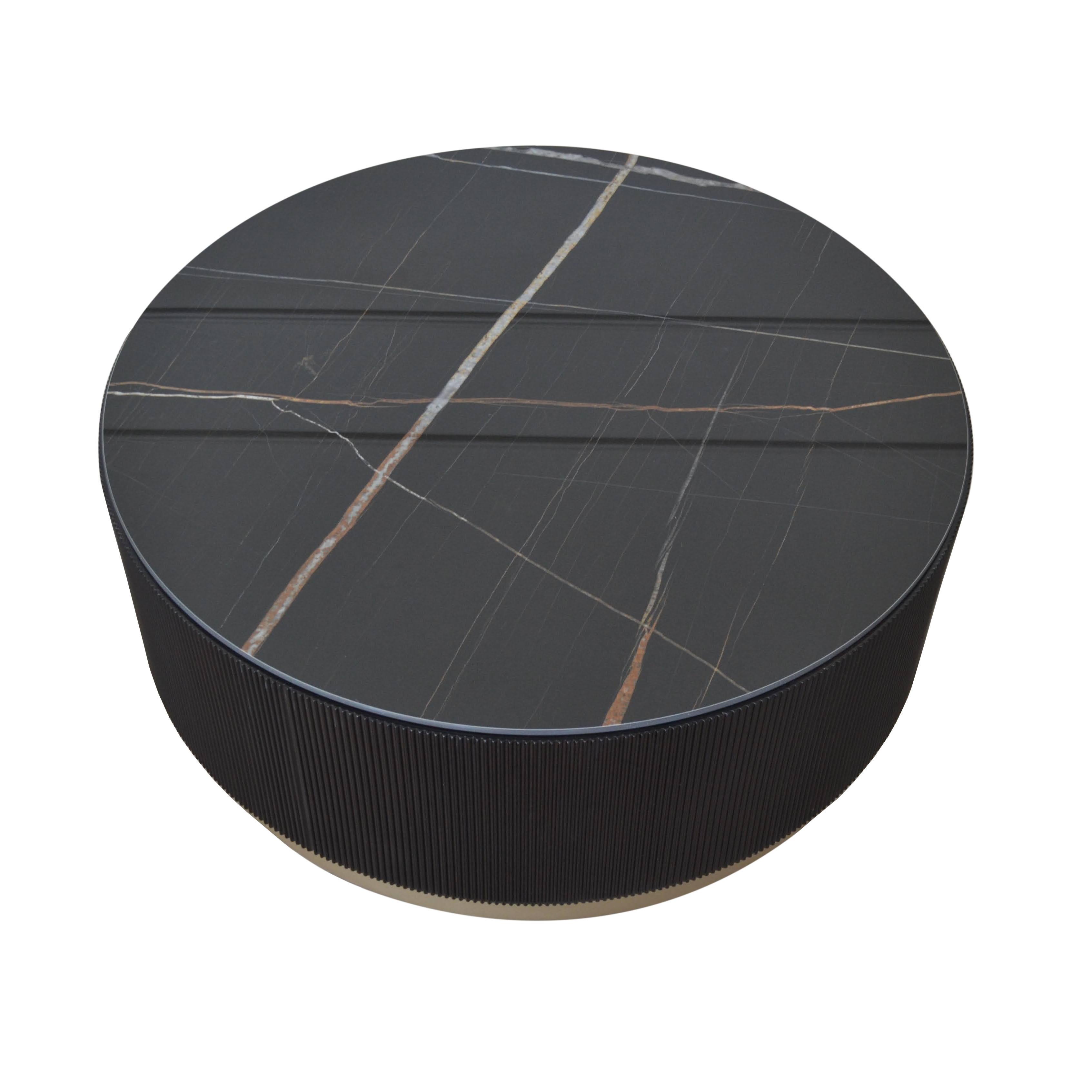 Exceptional in its craftwork, is a centre table that rejects traditional conventions in favour of experimentation. Round ceramic top imitating nero marquina marble is placed on a lacquered base, creating a sense of movement that evokes the motion of