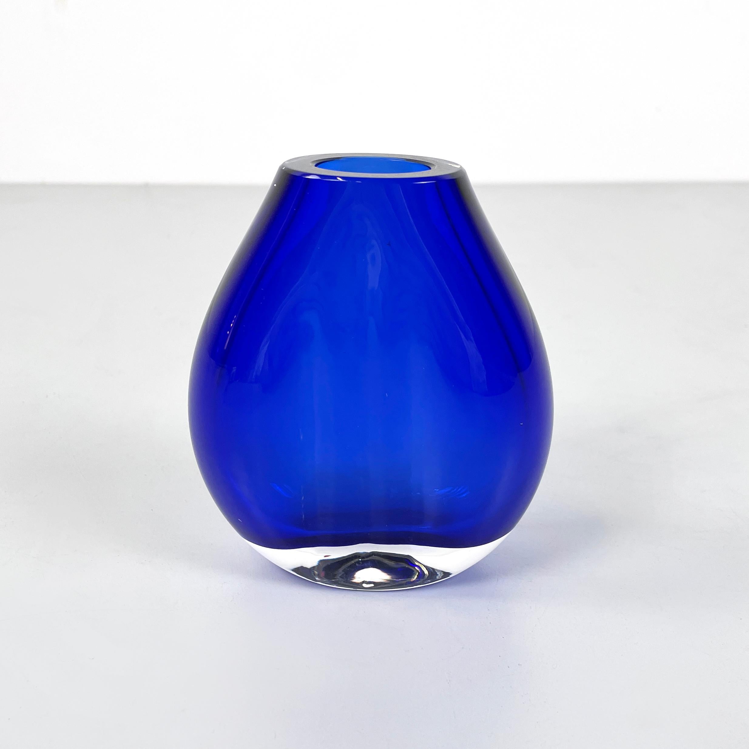 Italian modern Round vase in transparent and blue Murano glass by Venini 1990s
Vase with an oval base in thick blue and transparent Murano glass. At the top it has an oval hole. The structure widens and then narrows on the sides and remains flat in